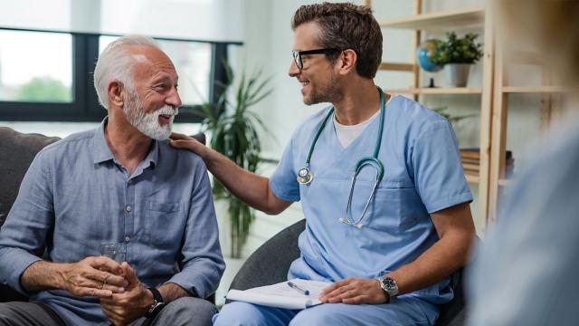 A man looks at this provider who touches his shoulder. 