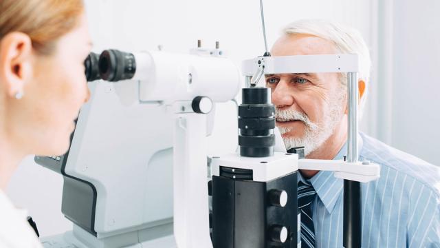 a senior man getting an eye exam at the optometris