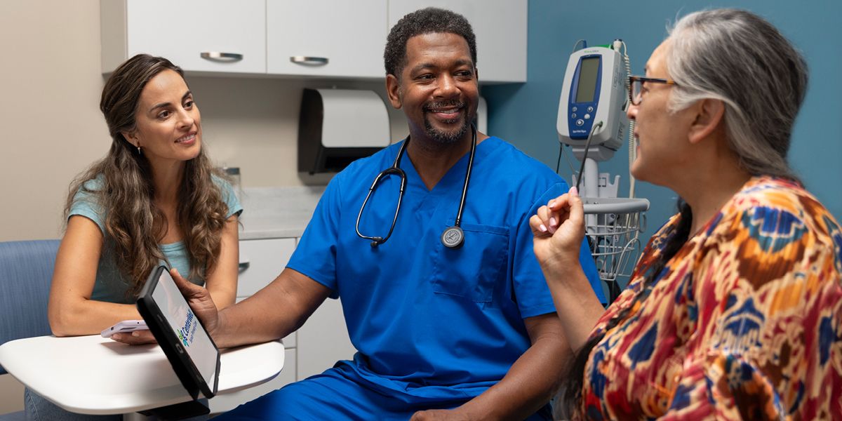 Doctor in office with patients 