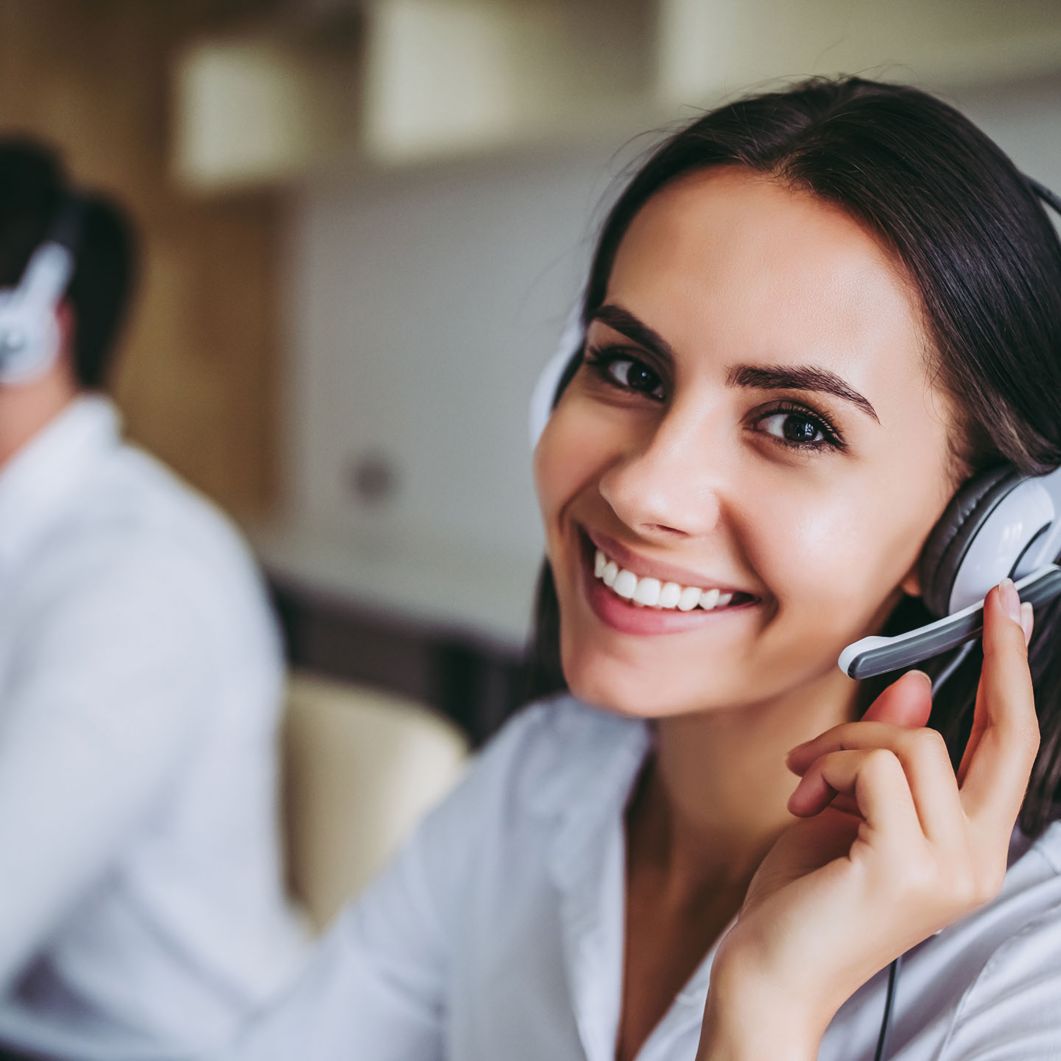 Woman talking on headset.