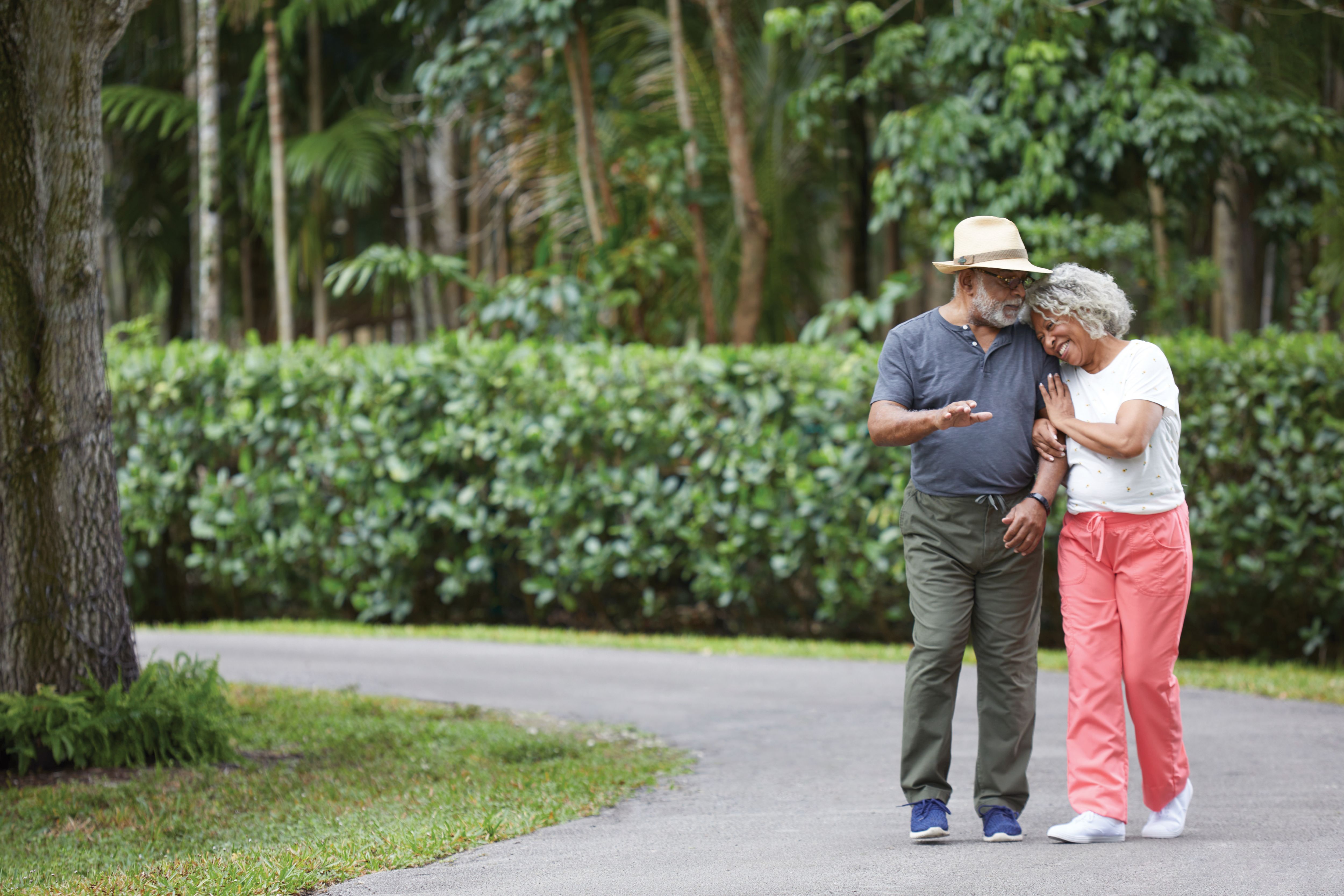 Member couple walking together in the park and laughing