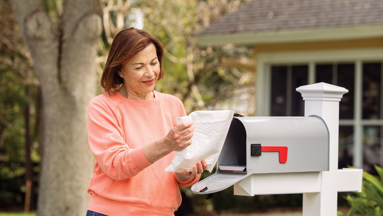 A woman receives her mail-order prescription