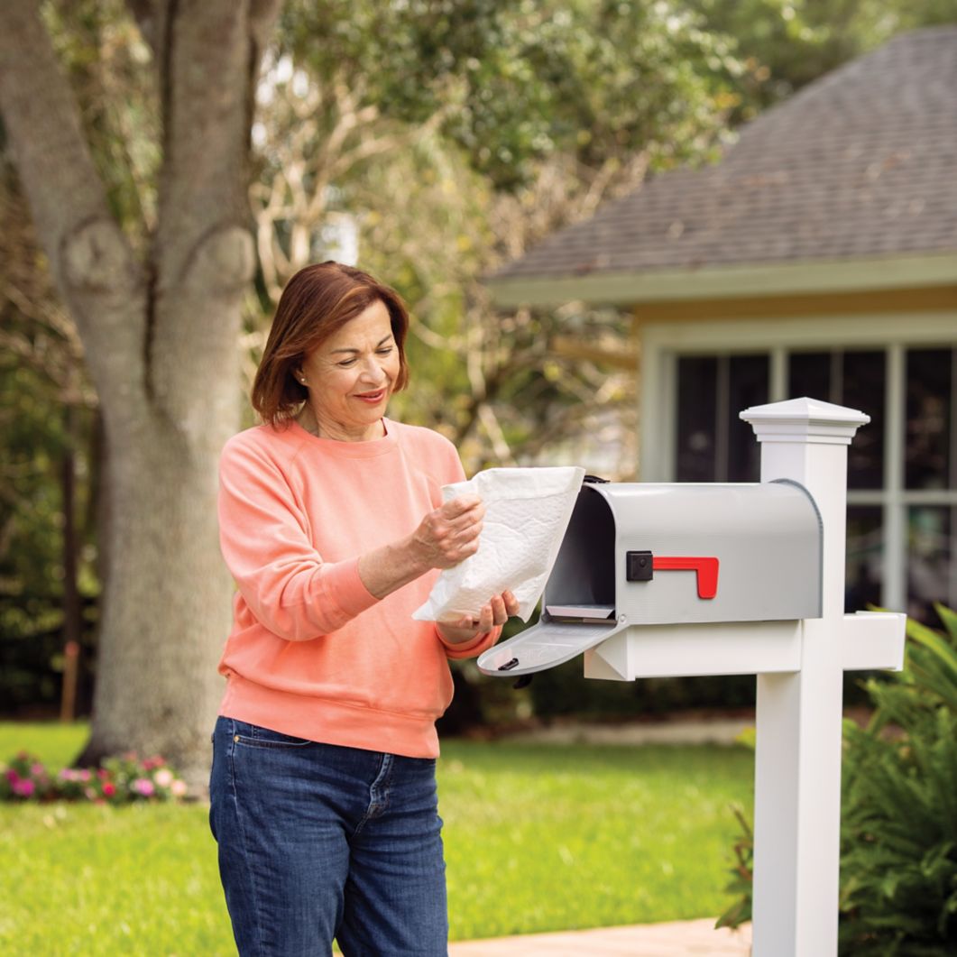 A woman receives her mail-order prescription