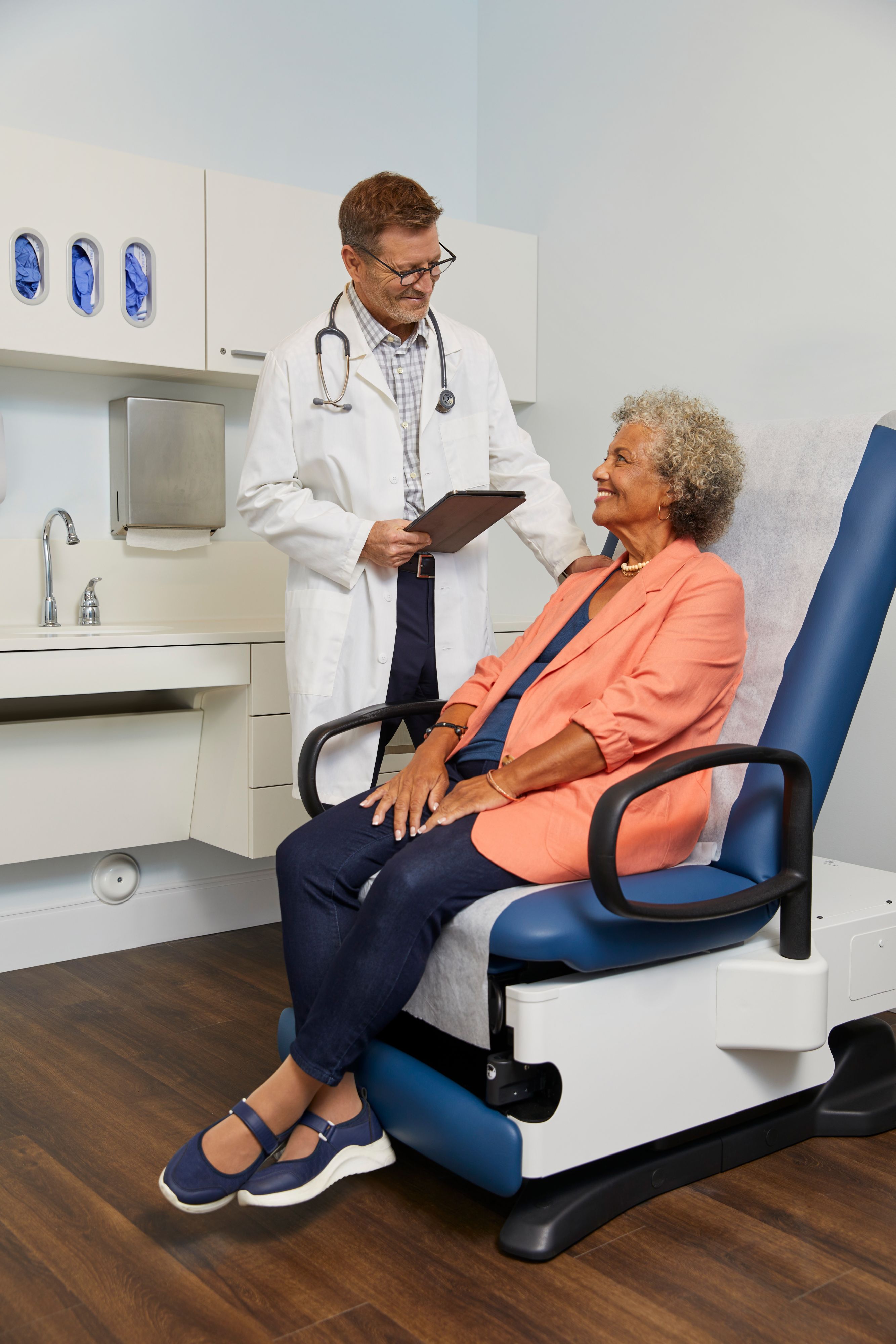 A woman chats with her doctor during an office visit