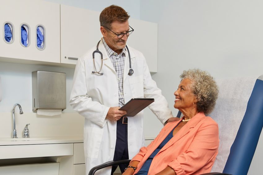 A woman chats with her doctor during an office visit