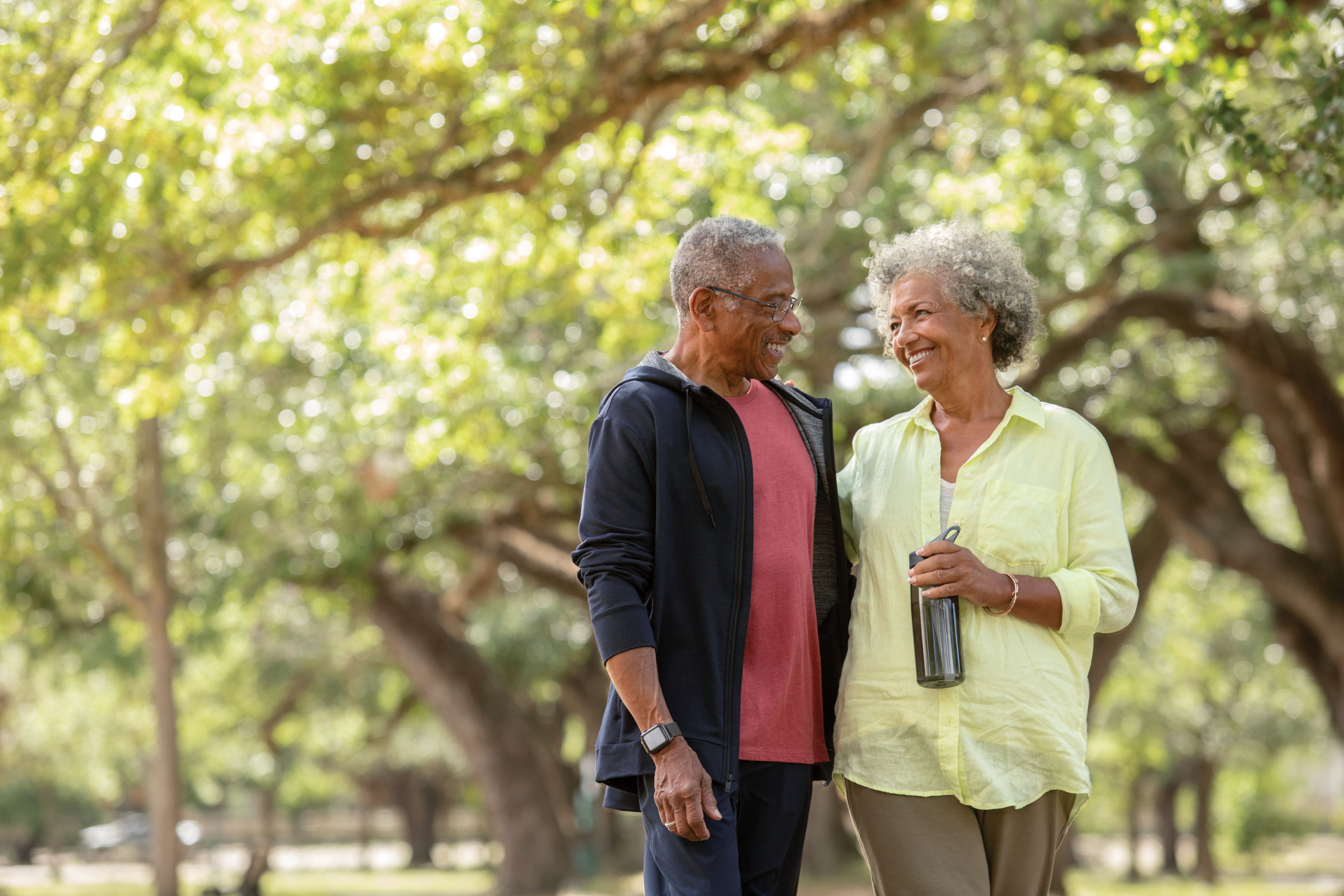 Senior couple enjoying leisure walk in the park together