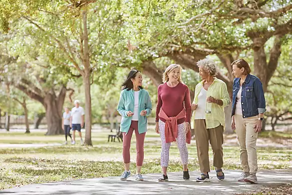 Group of senior women friends taking a walk together in the park