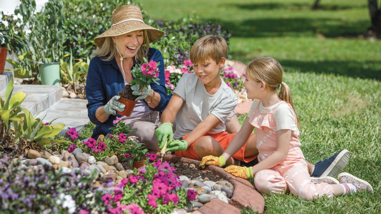 A woman gardens with her grandkids.