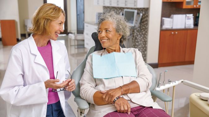 Senior woman having a dental exam with dentist.