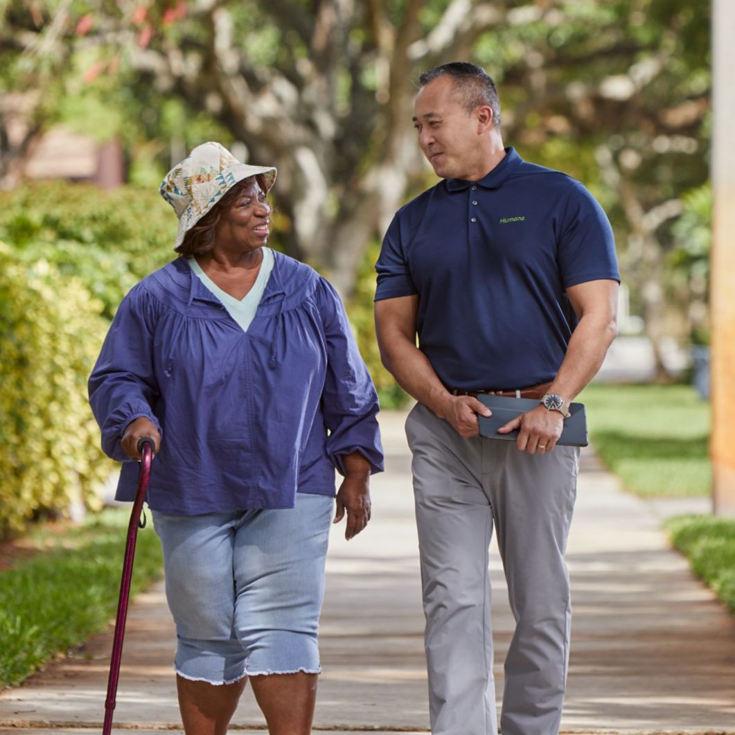 Man and woman walking down a sidewalk.