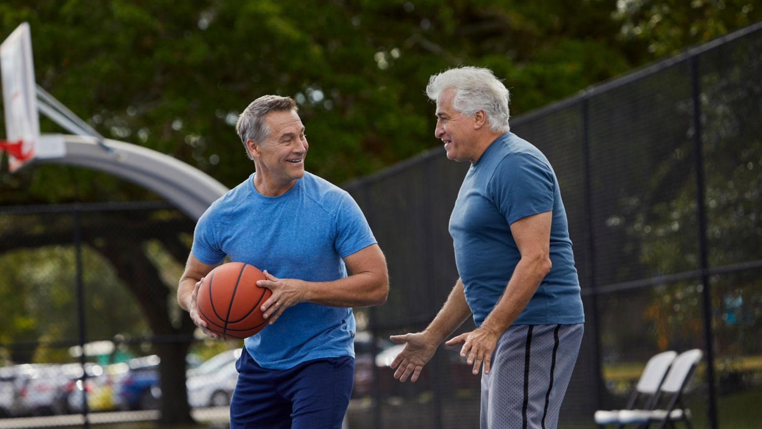 Two senior men playing basketball
