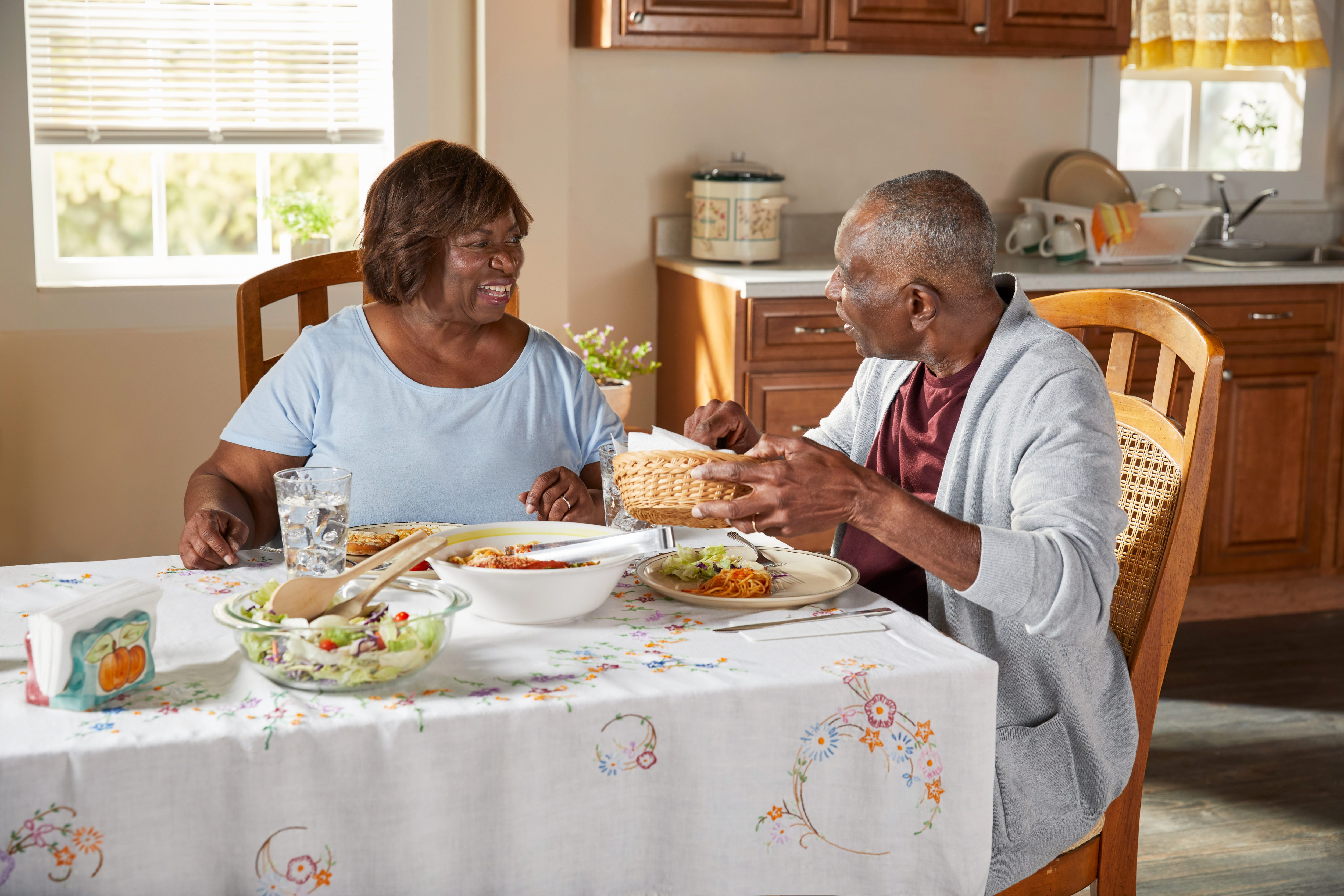 Senior couple talking at kitchen table
