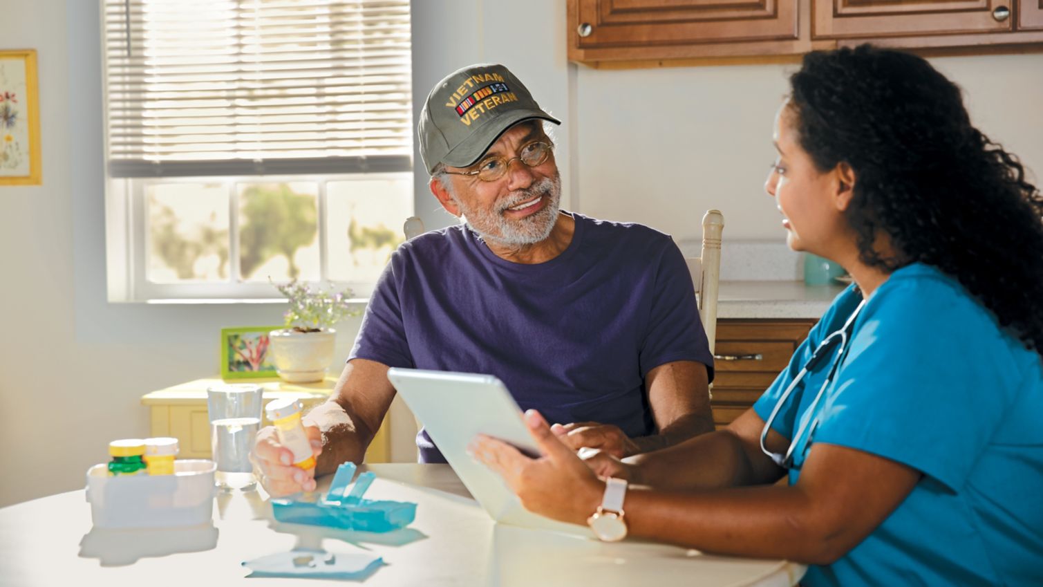 A female doctor going over a patient's information on a tablet