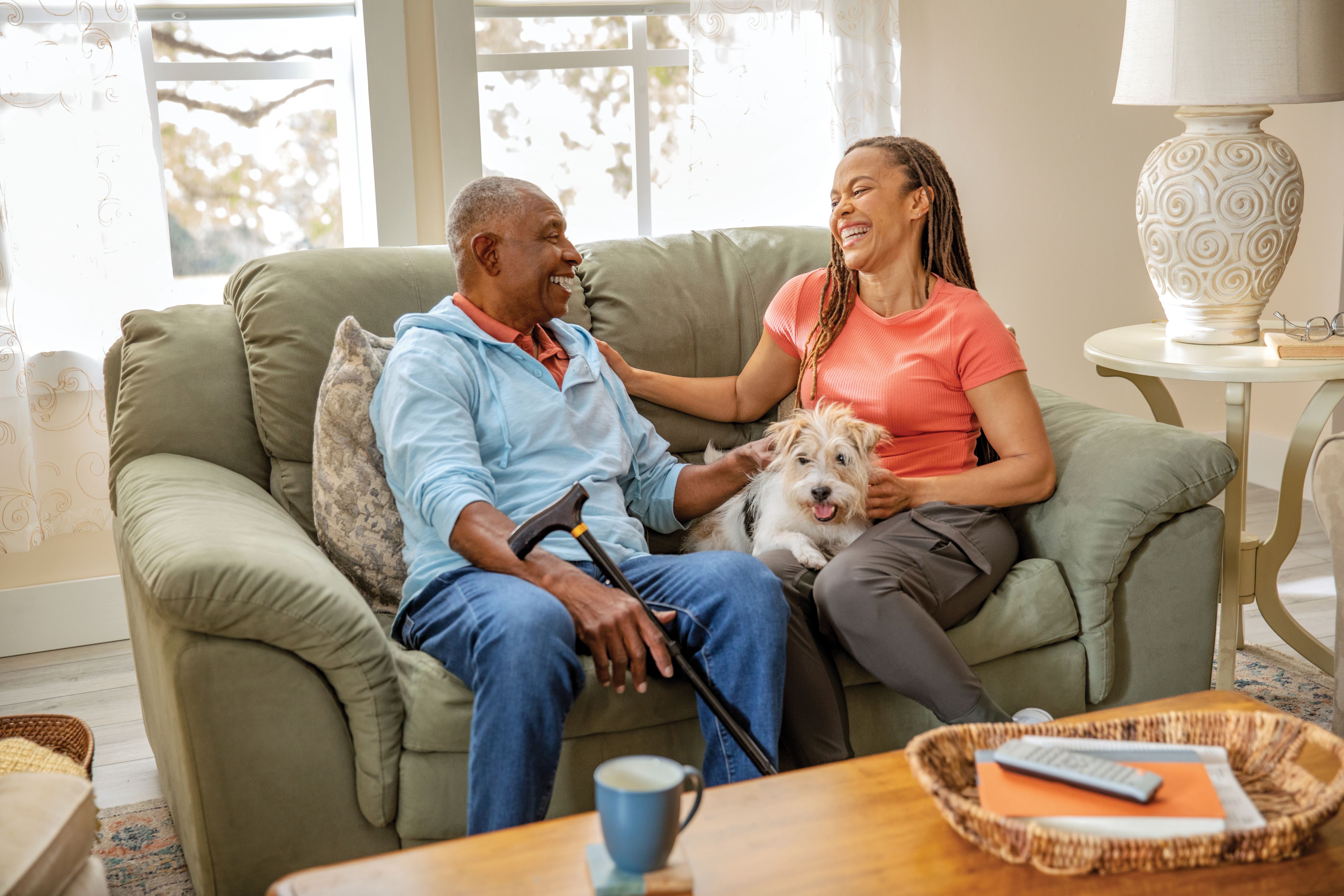 Senior man with adult daughter and dog visiting together