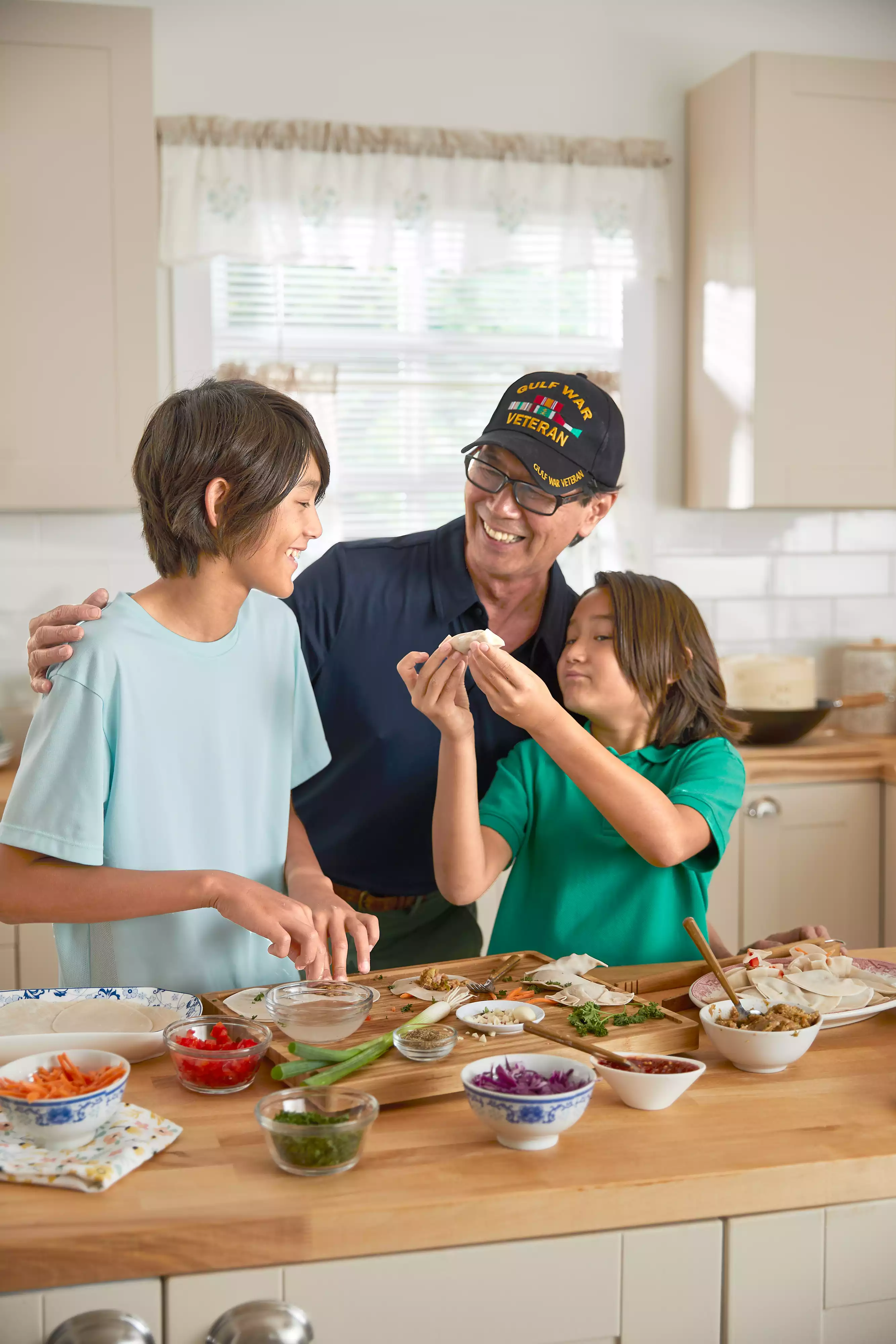 Senior man is preparing a meal with his grandchildren in the kitchen