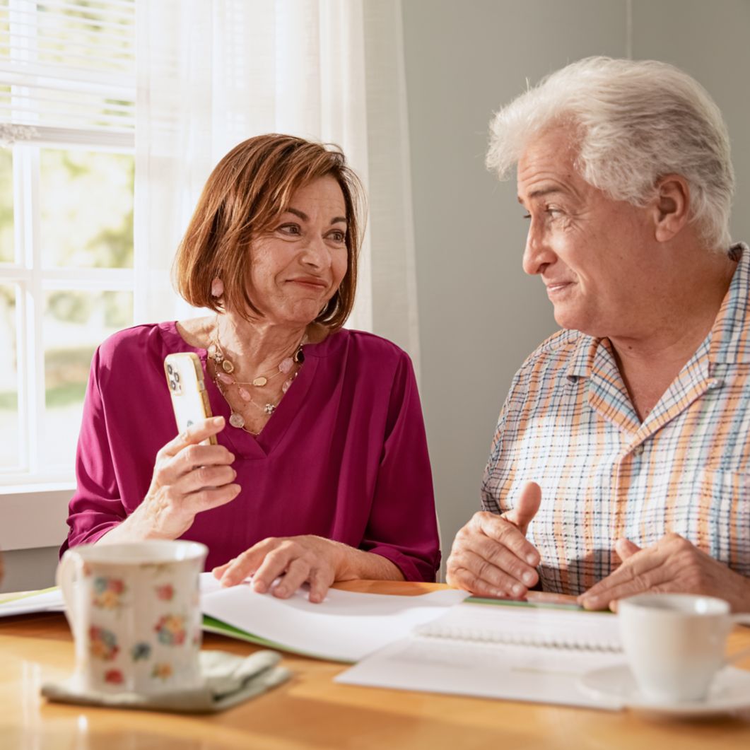 Man and woman doing paperwork at a table.