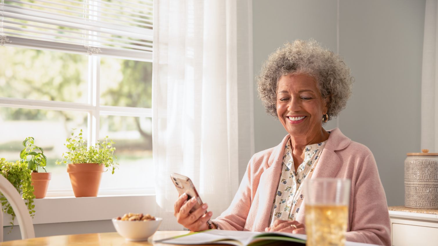 A woman reviews a booklet in her home.