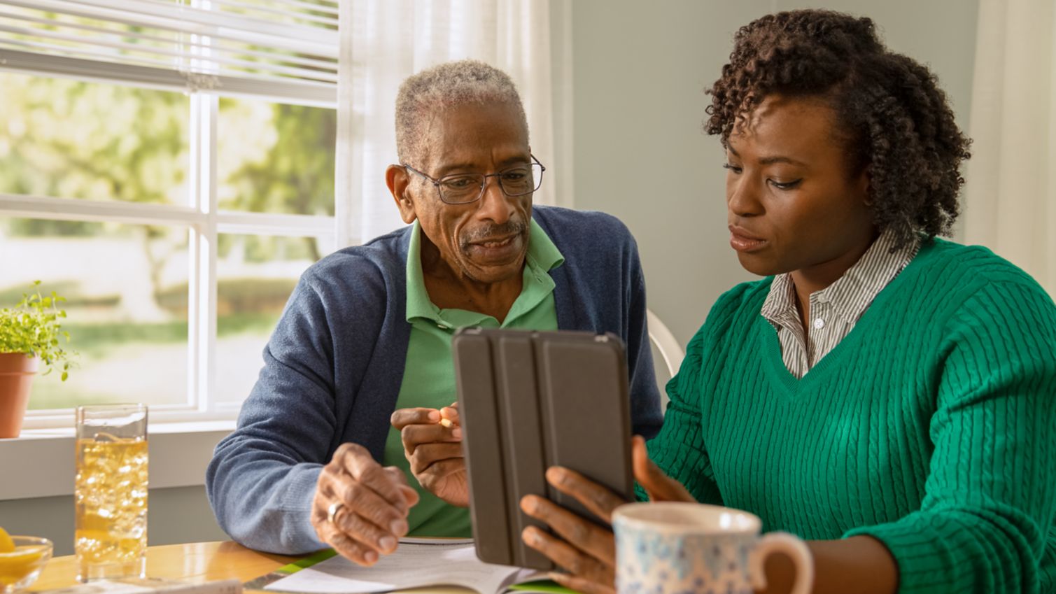 A woman flips through papers on a clipboard with 2 adults.