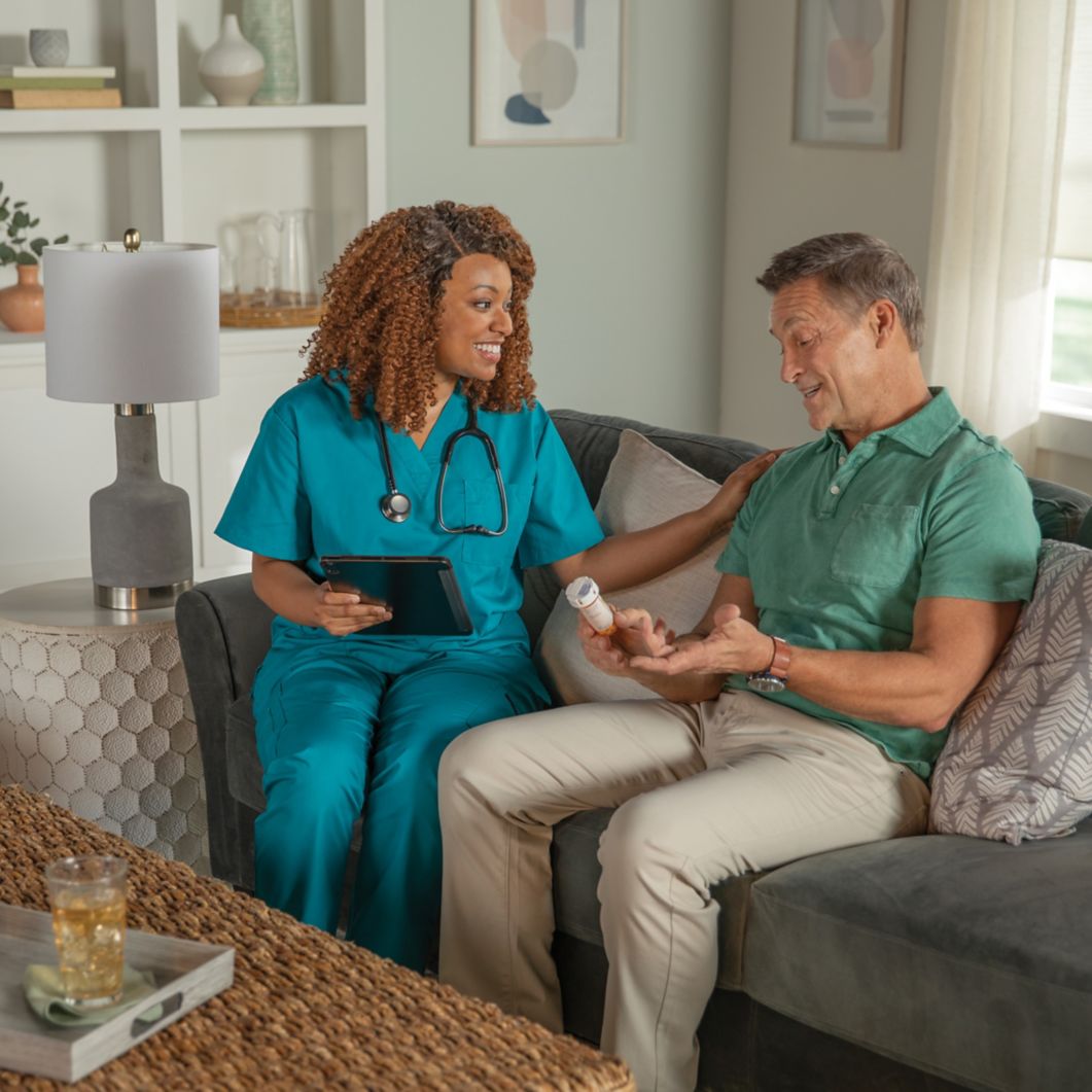 A caregiver goes over a patient's medicine information