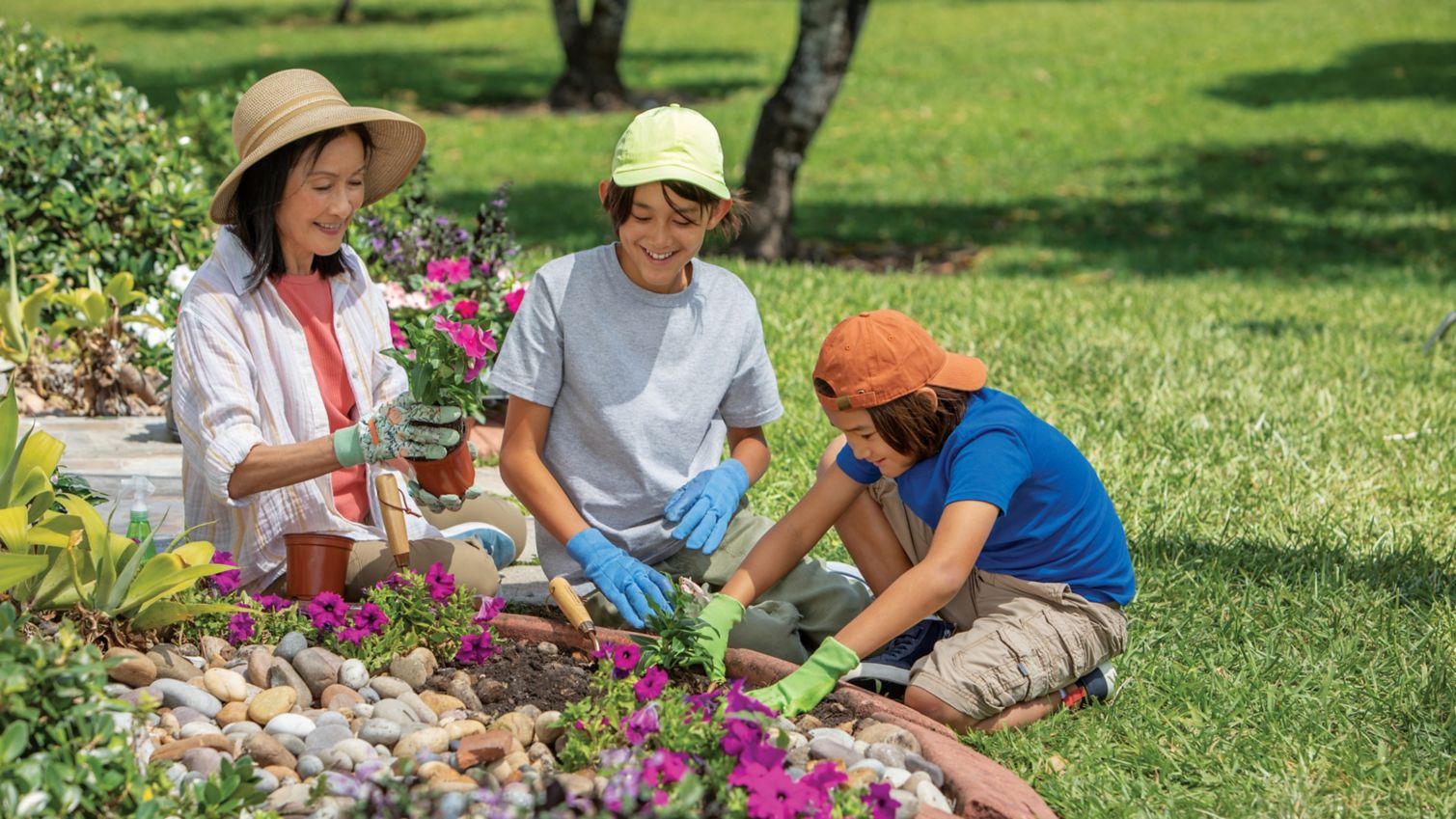 A woman gardens with her grandkids.