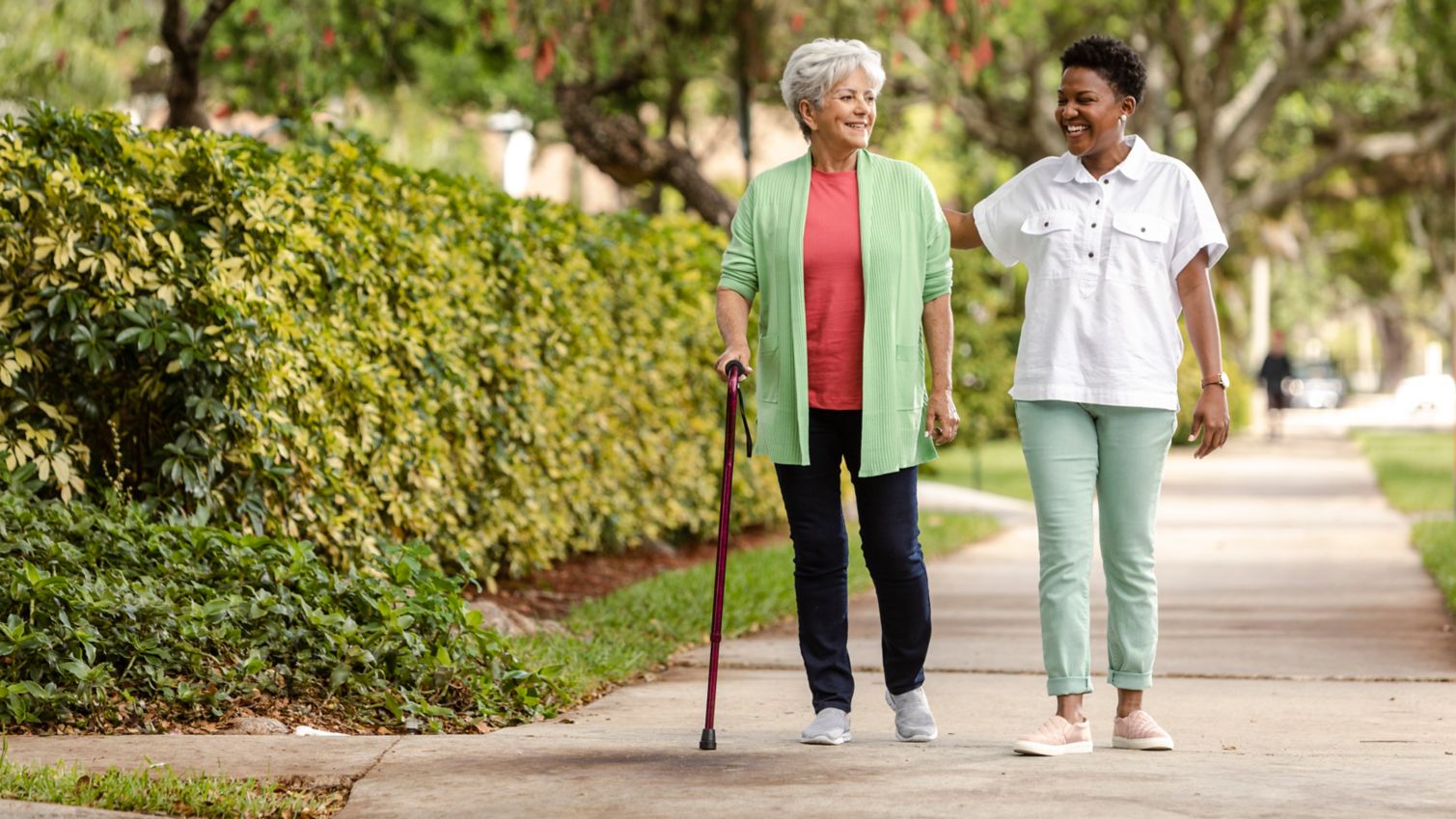 A caregiver and patient taking a walk