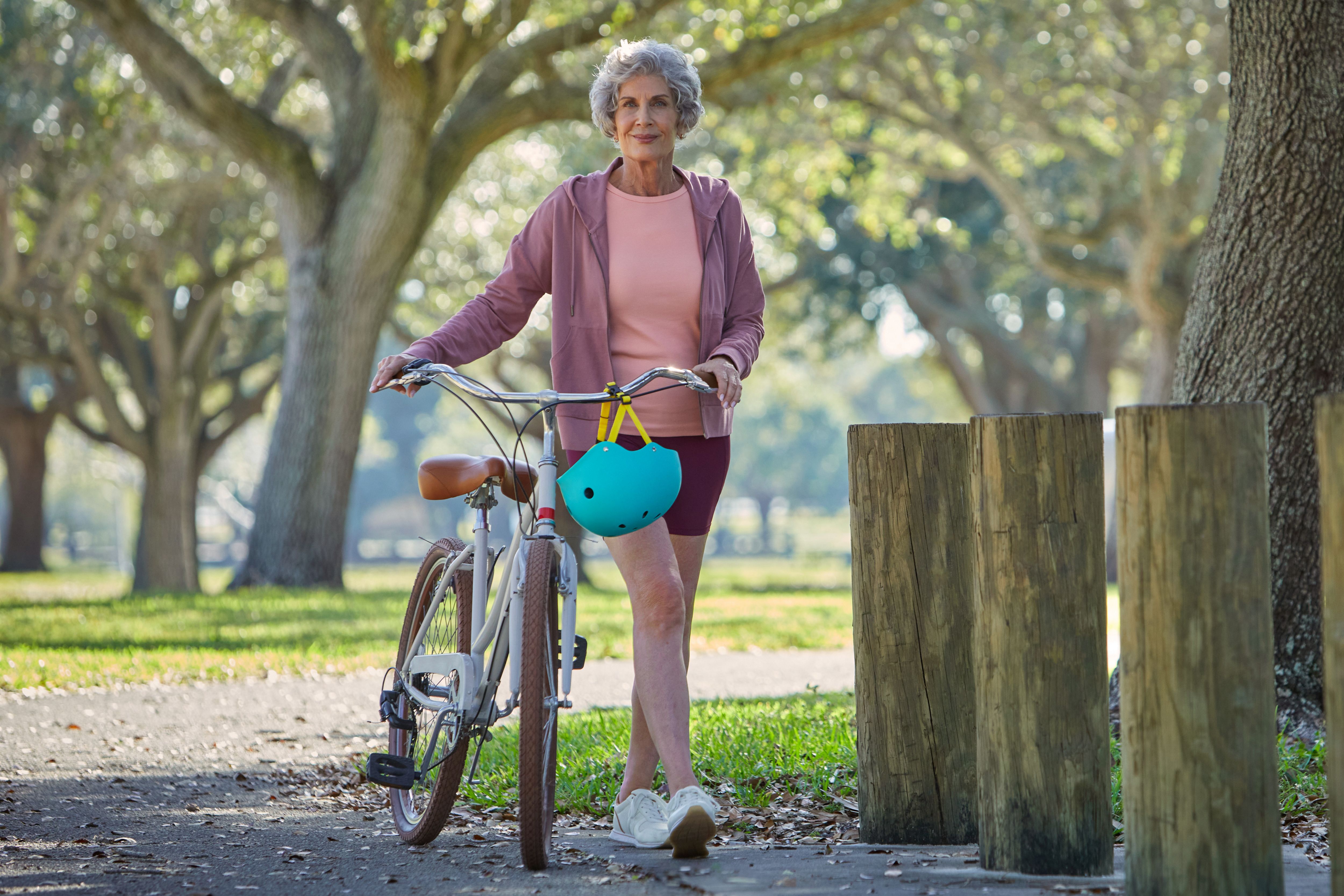 Senior woman riding bike at the park