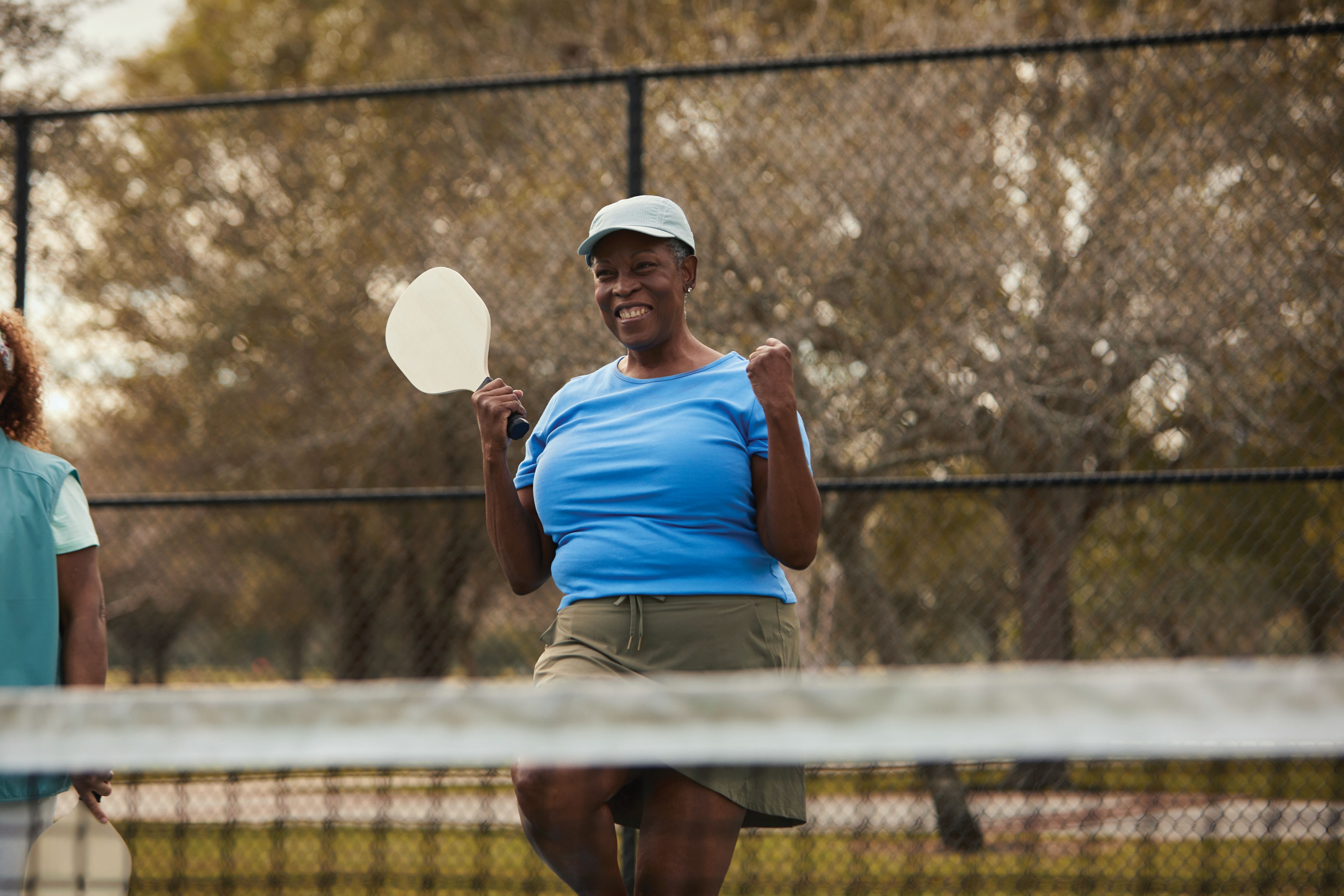 Seniors playing pickleball at the park courts
