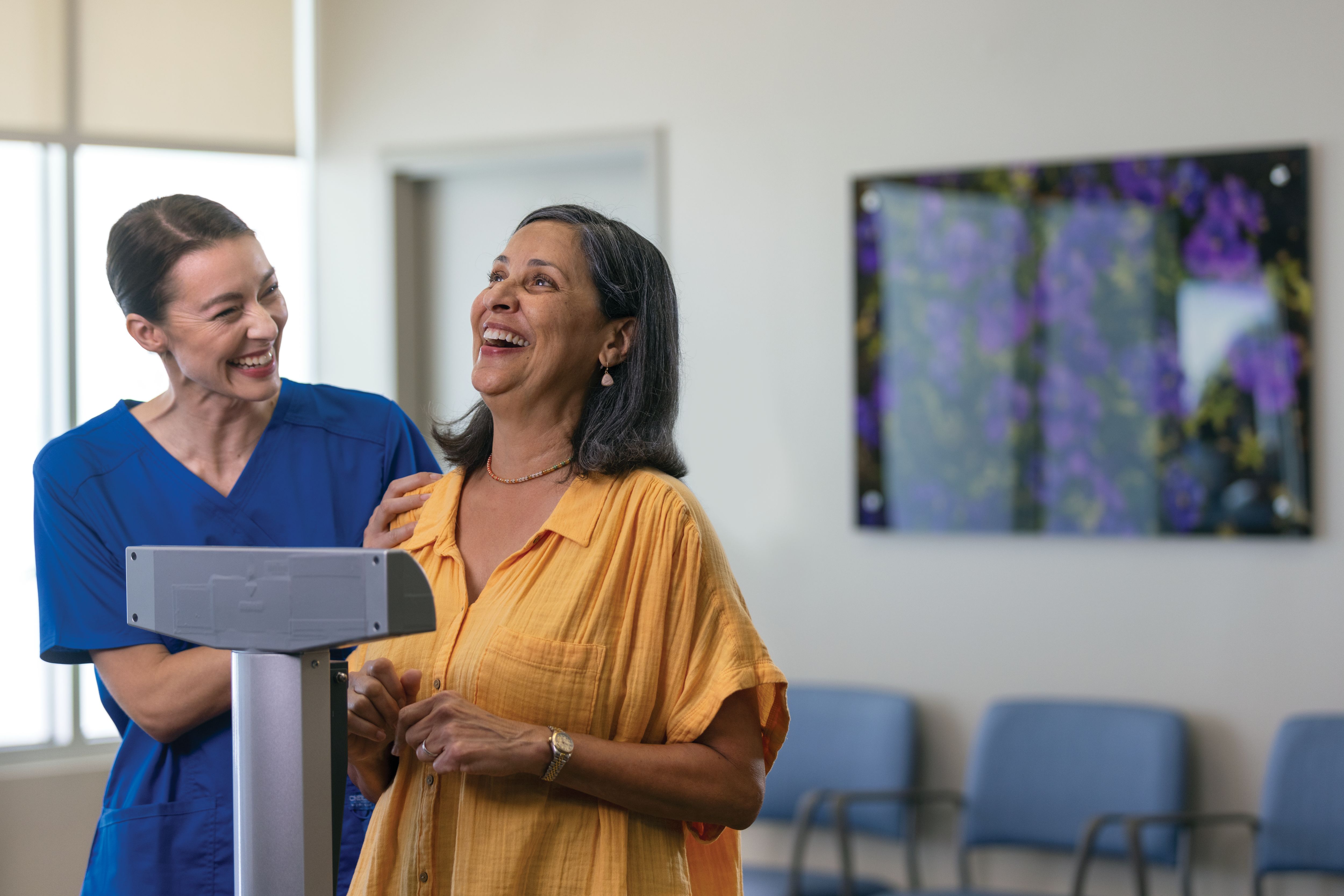 Hispanic woman and nurse on scale