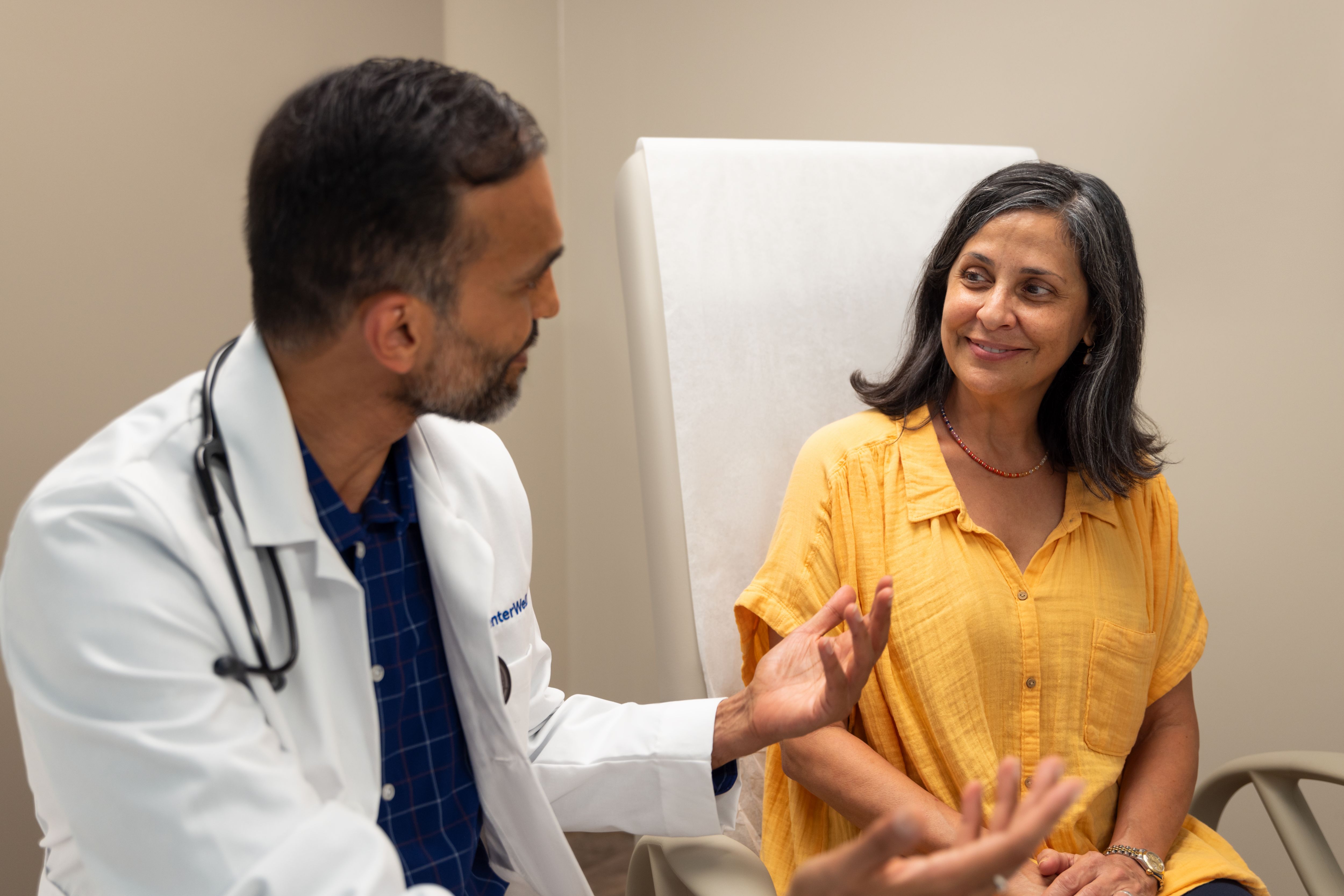 Hispanic female with black indian in doctors office