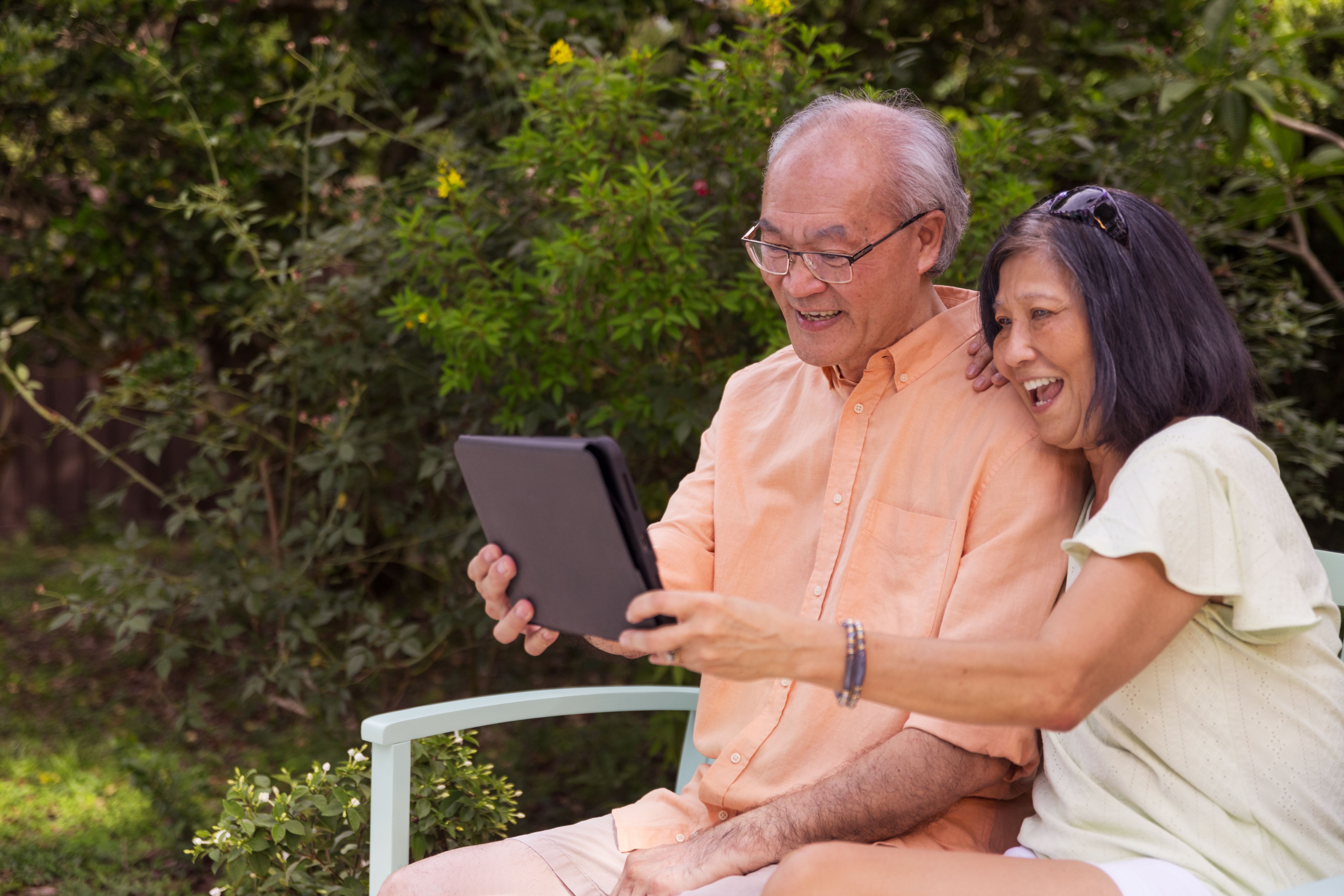 Asian couple looking at iPad