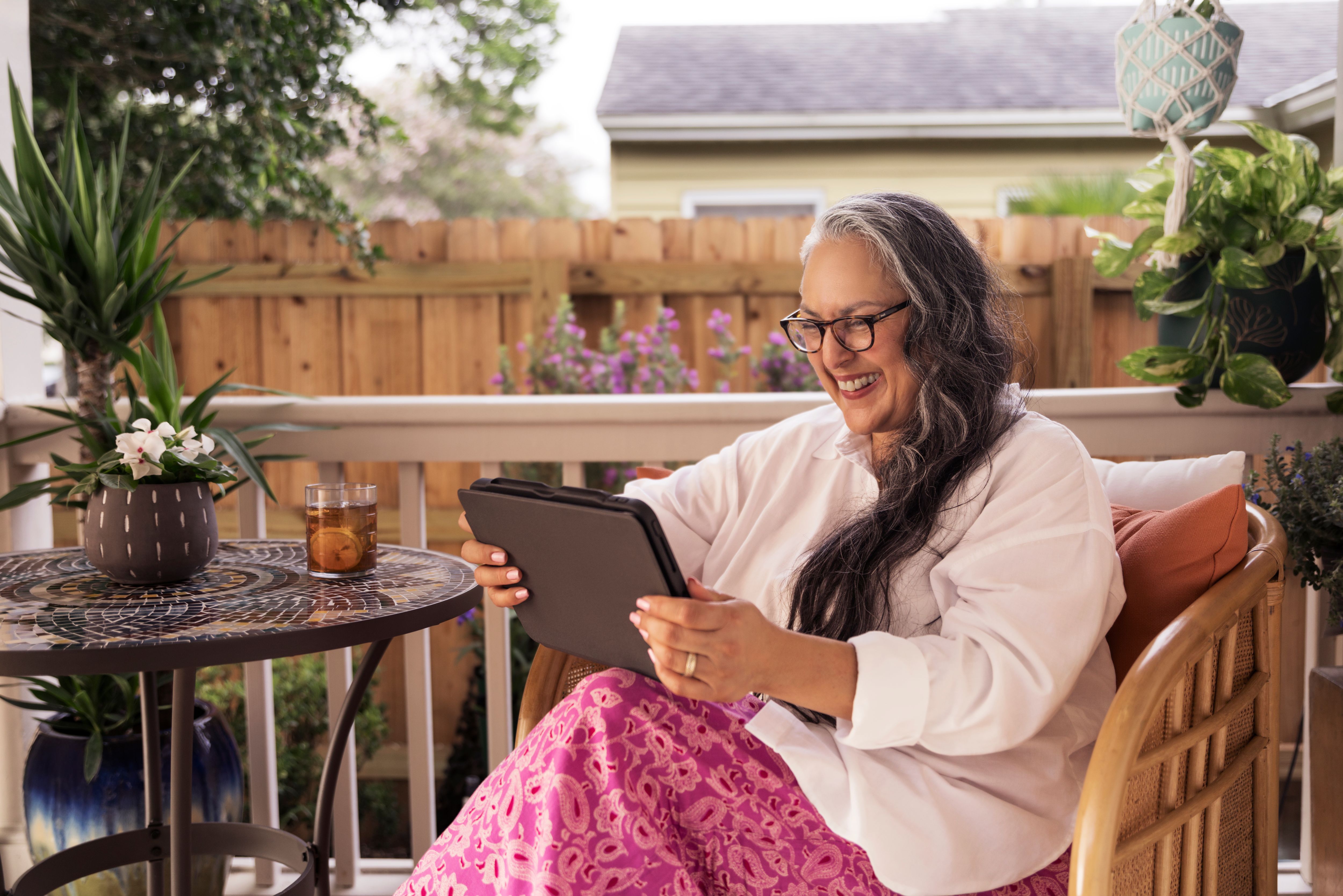 Hispanic female holding iPad outdoors