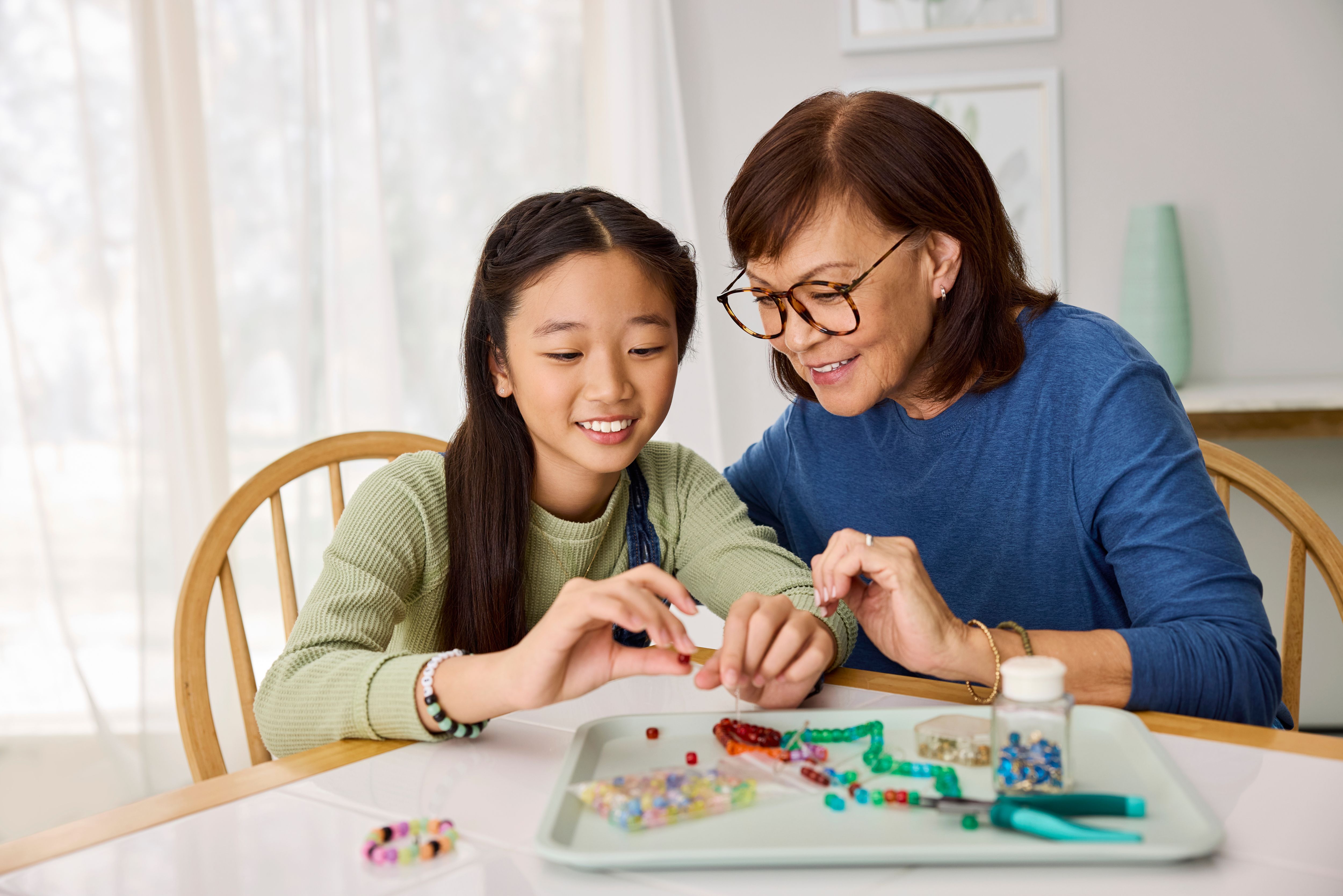 grandmother and granddaughter sitting at the kitchen table 
