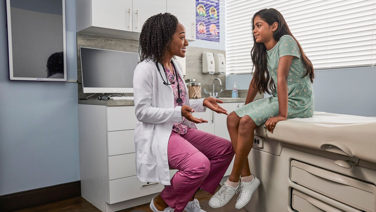 Teen and pediatrician talking during exam