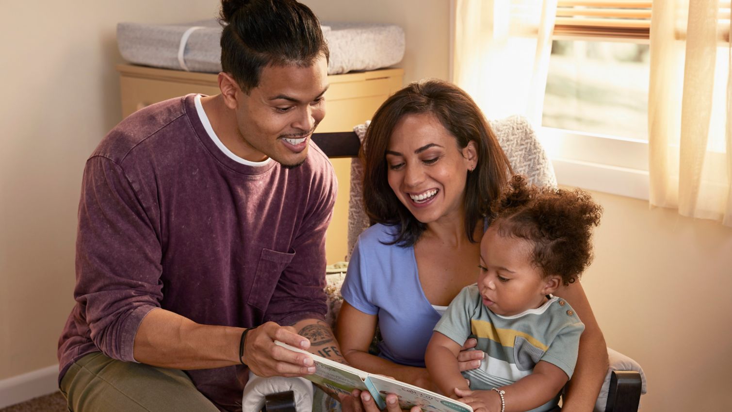 Parents reading a book with a child