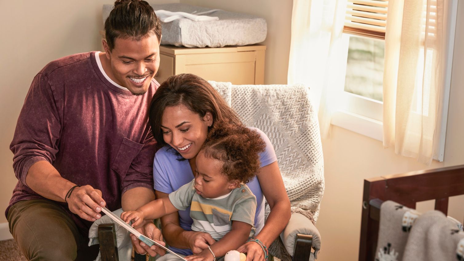 Happy partent read book to infant
