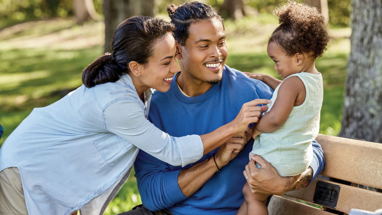 Dad, mom and daughter in the park
