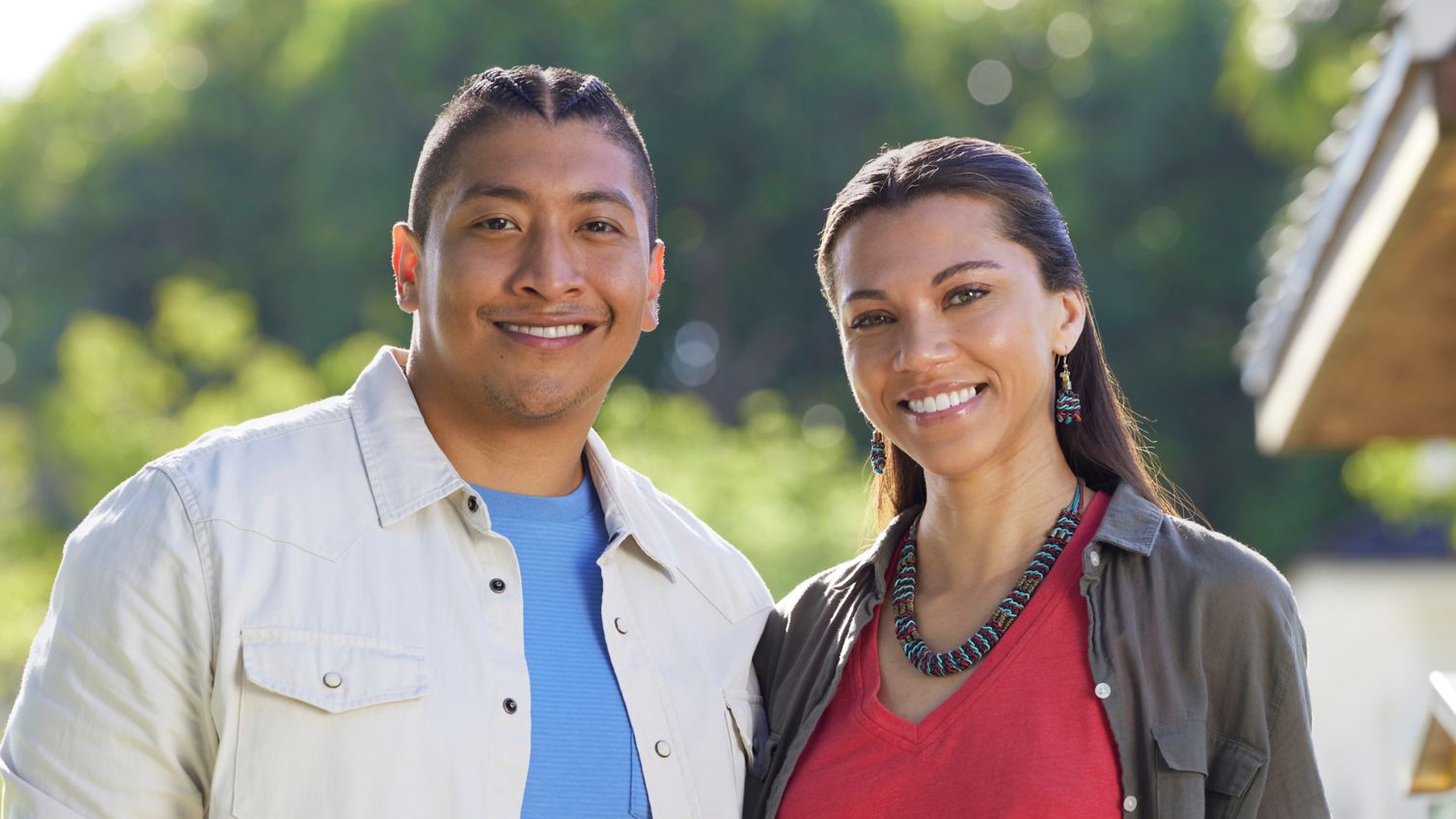 Two adults smiling in the sunshine