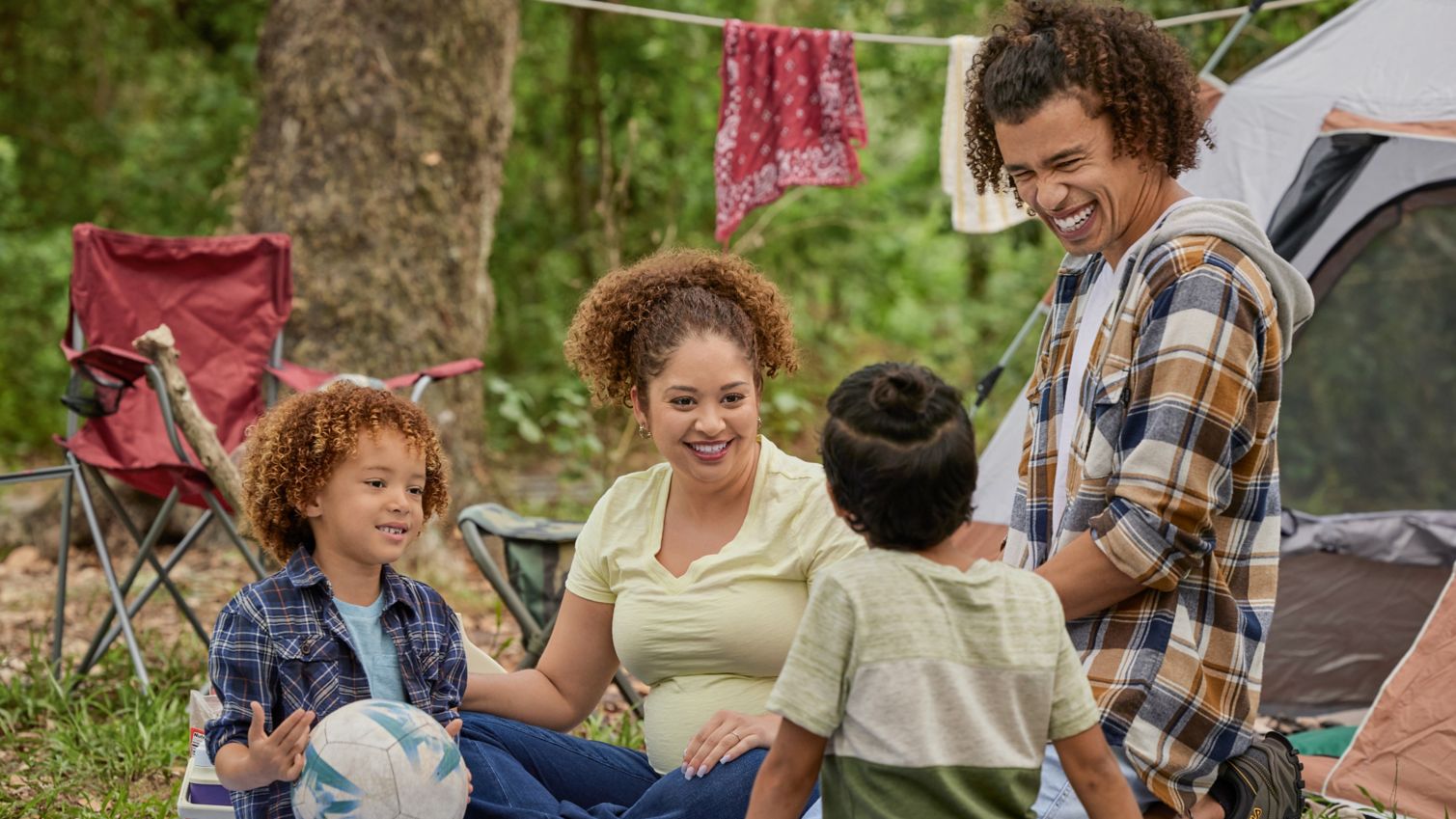 Family sitting together while camping