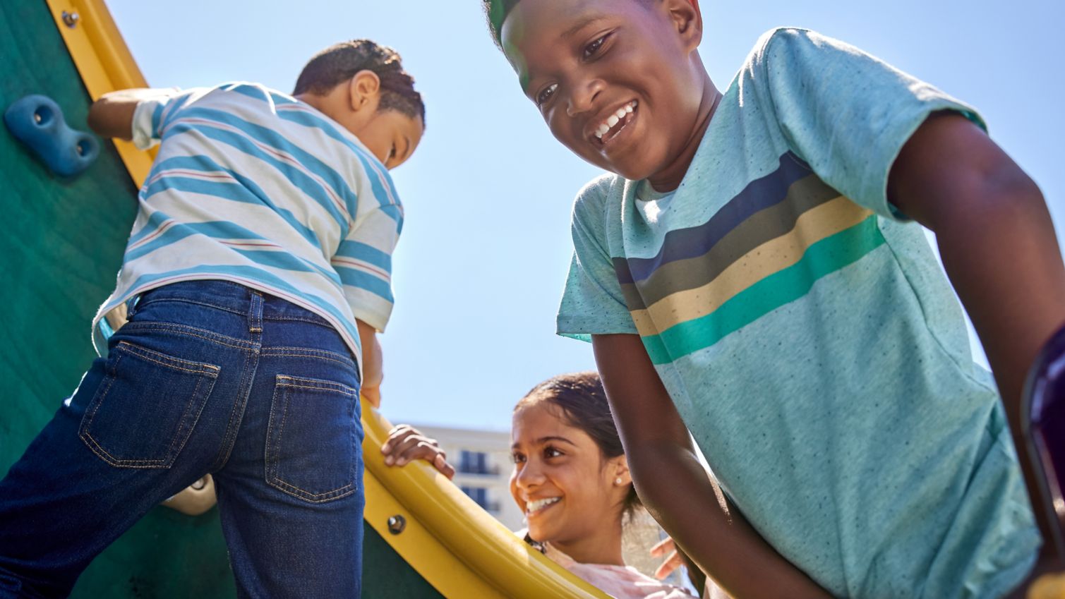 Teen and child play on playground