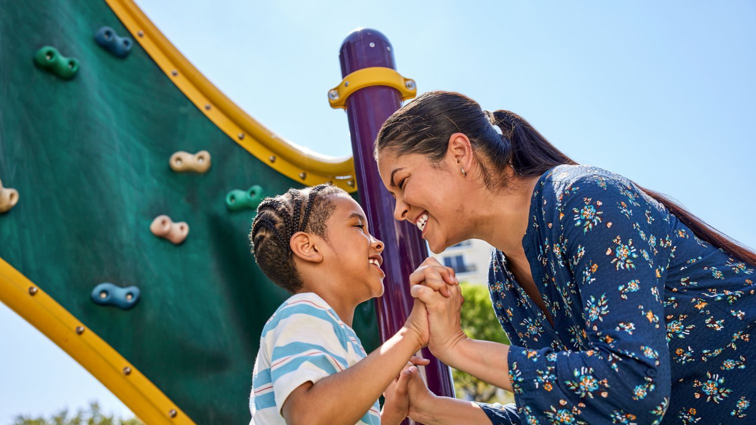 Child and parent playing on playground