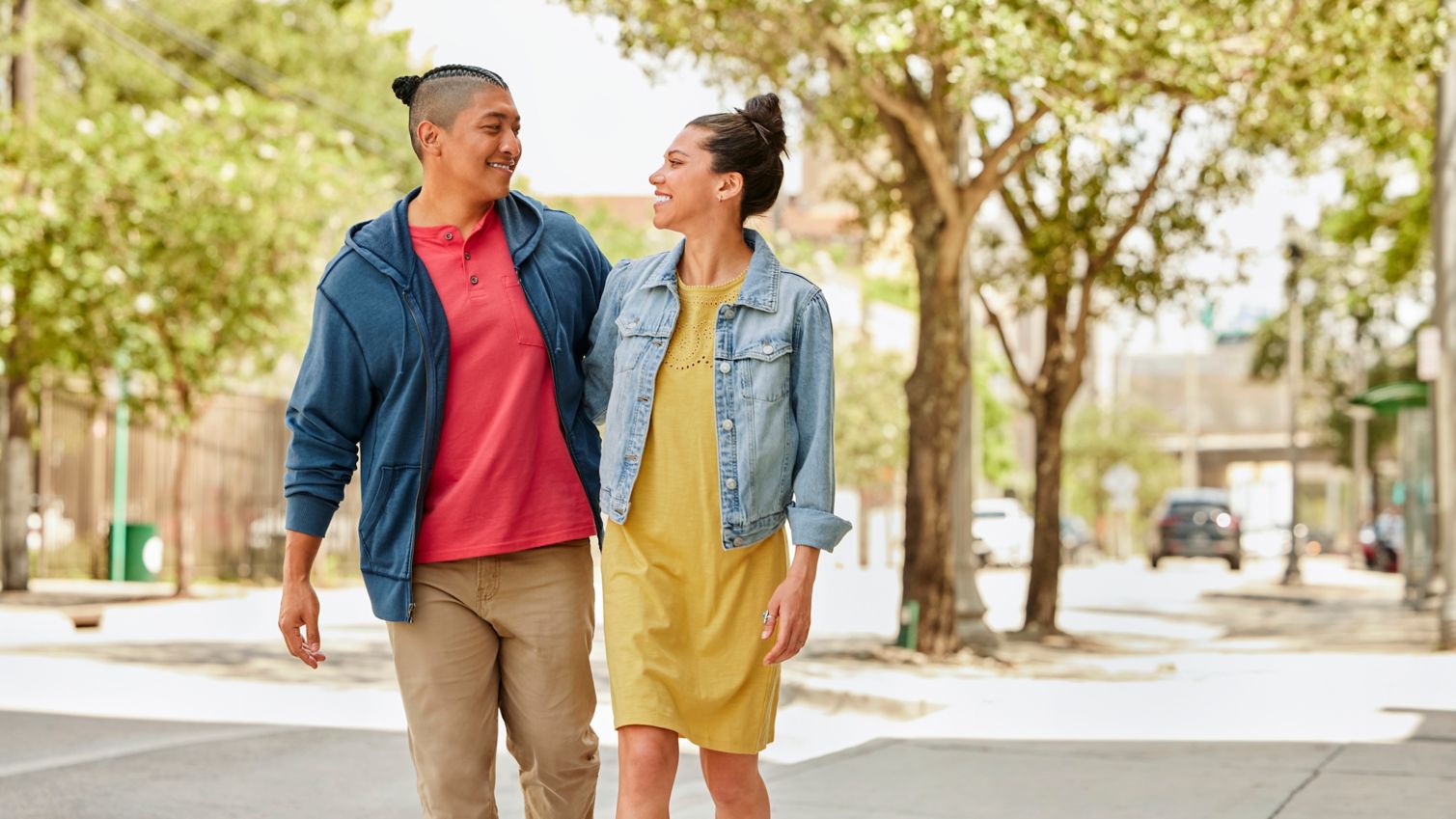 Two adults walking down the street together