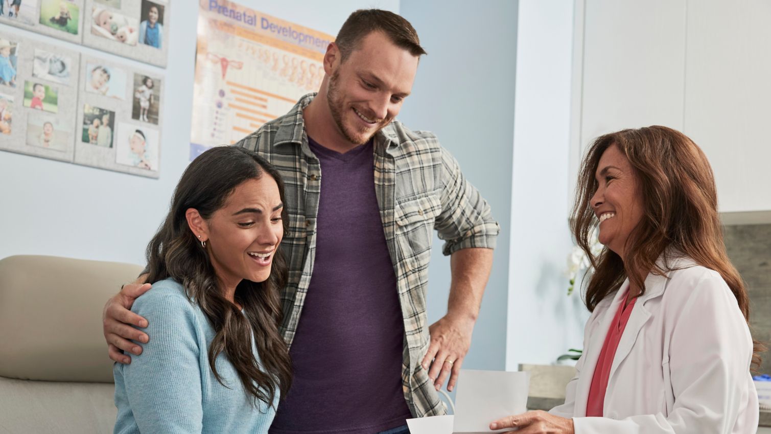 A couple in an exam room with a healthcare provider.