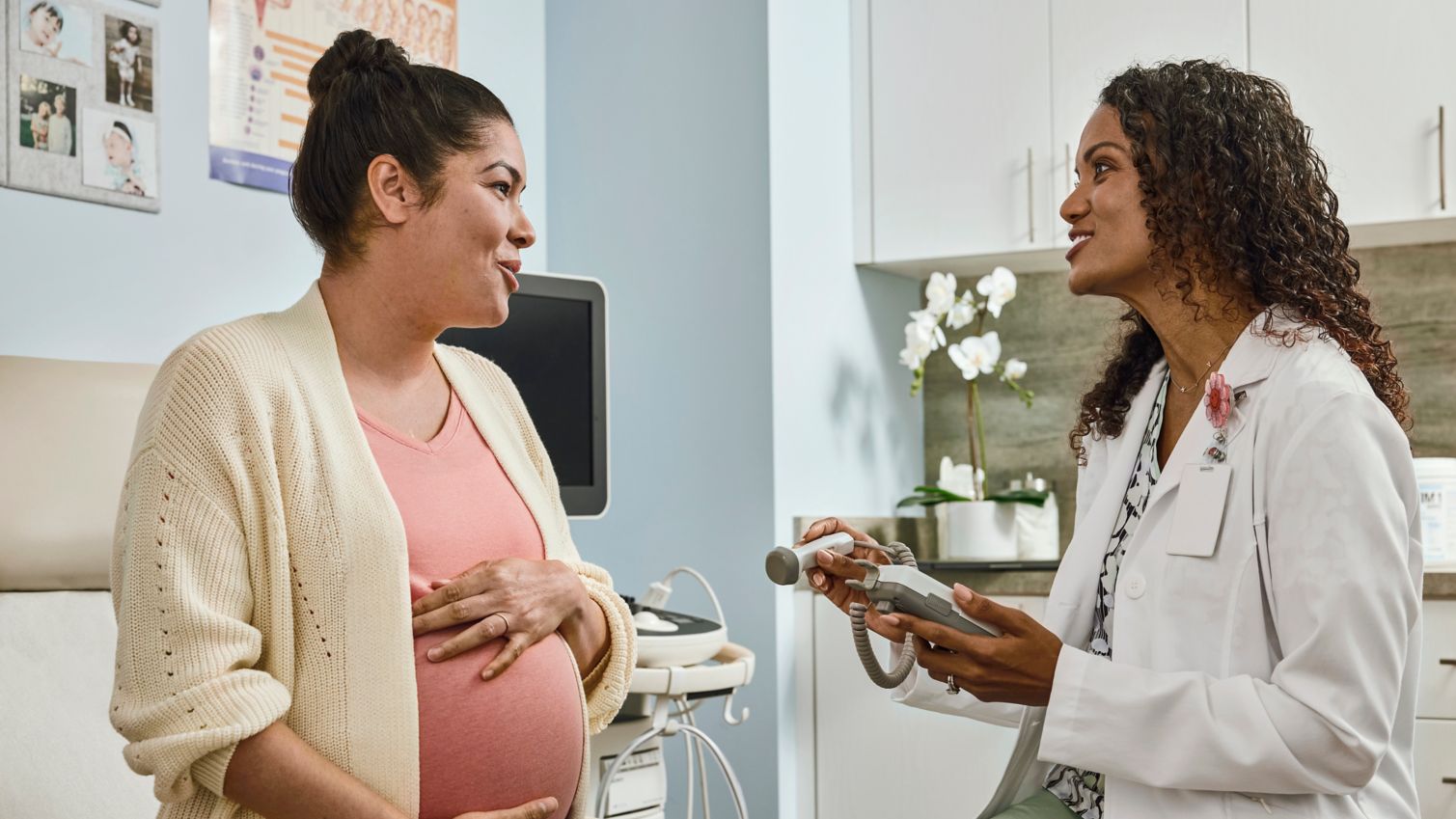 Adults viewing ultrasound photo with OBGYN
