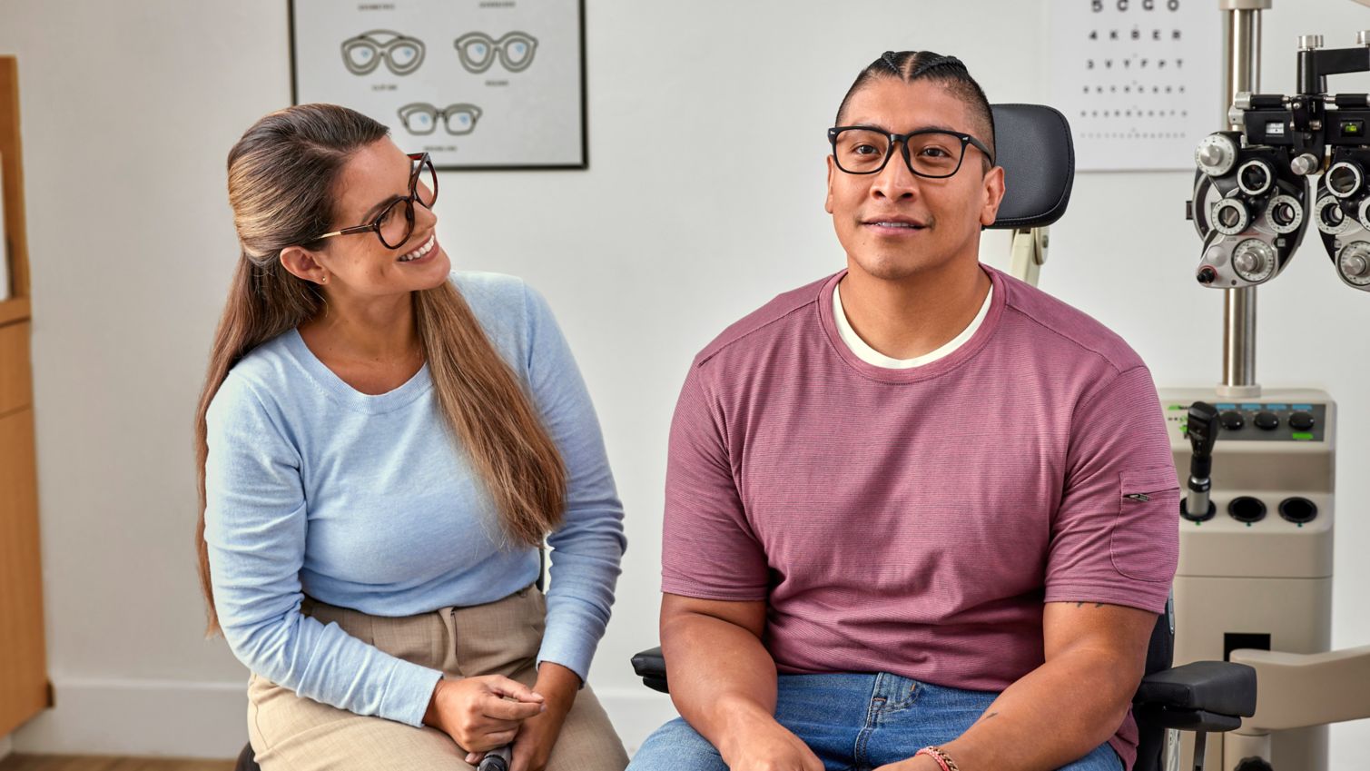 Adult patient in vision provider’s exam room with optometrist