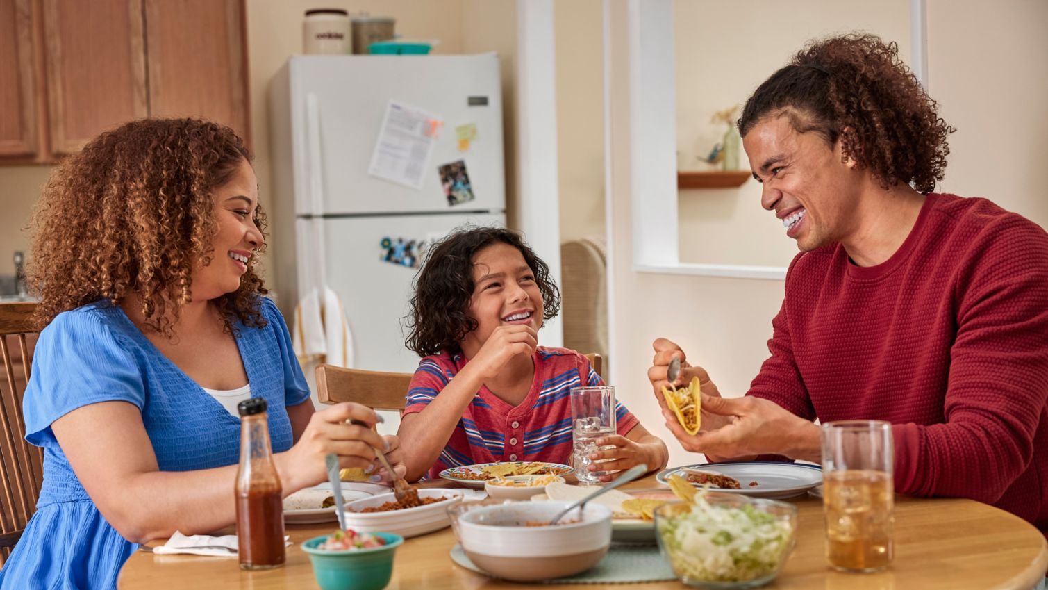 Parents and children eating dinner at table