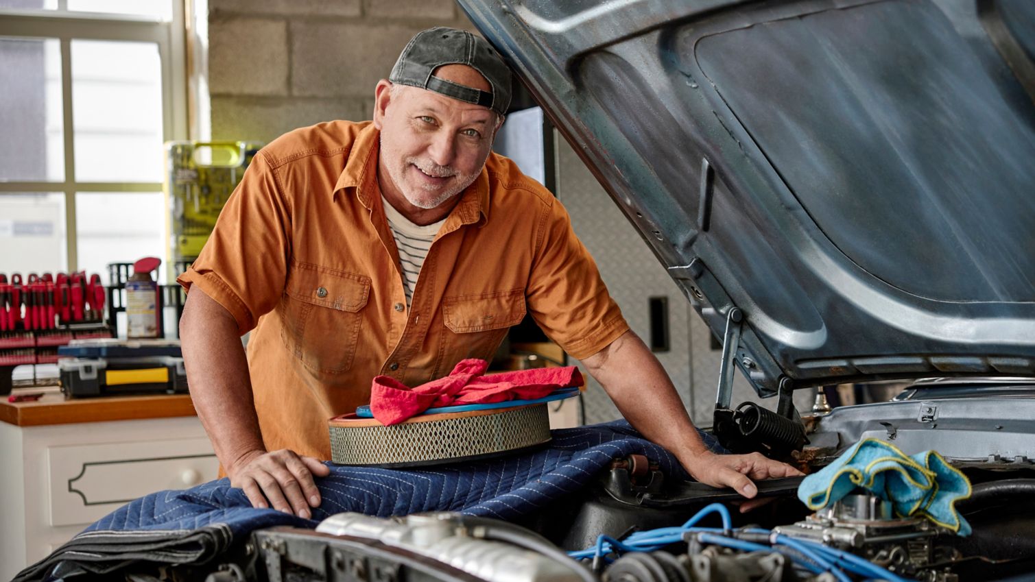 Man working on a car in his garage
