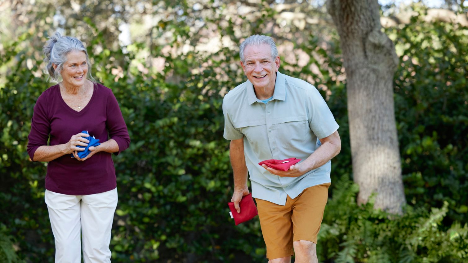 Seniors Playing cornhole outdoors in yard