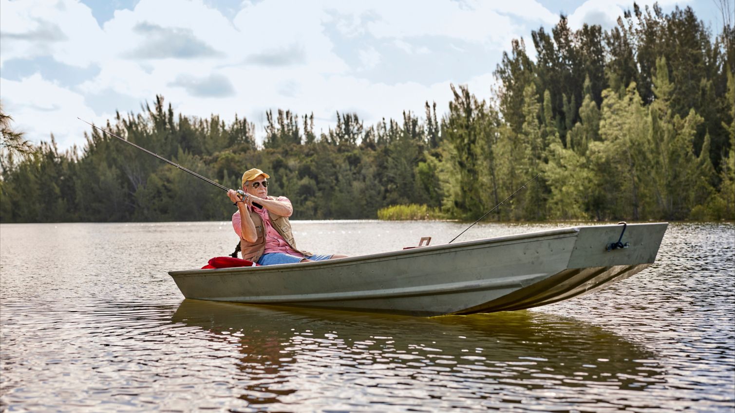 Senior on a boat, fishing