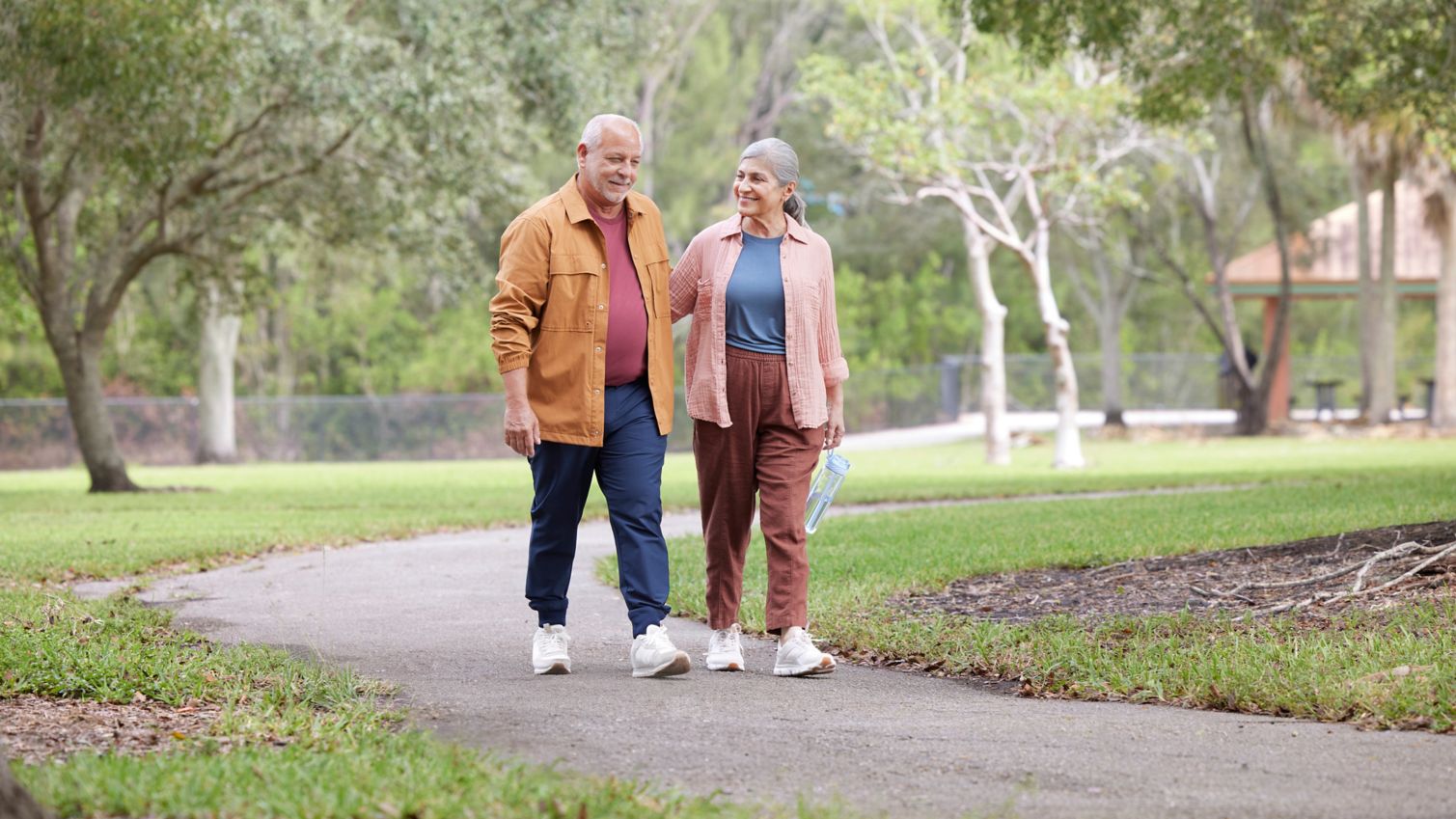Seniors walking in park being active exercising