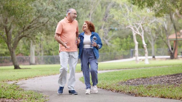 Seniors walking in park being active exercising